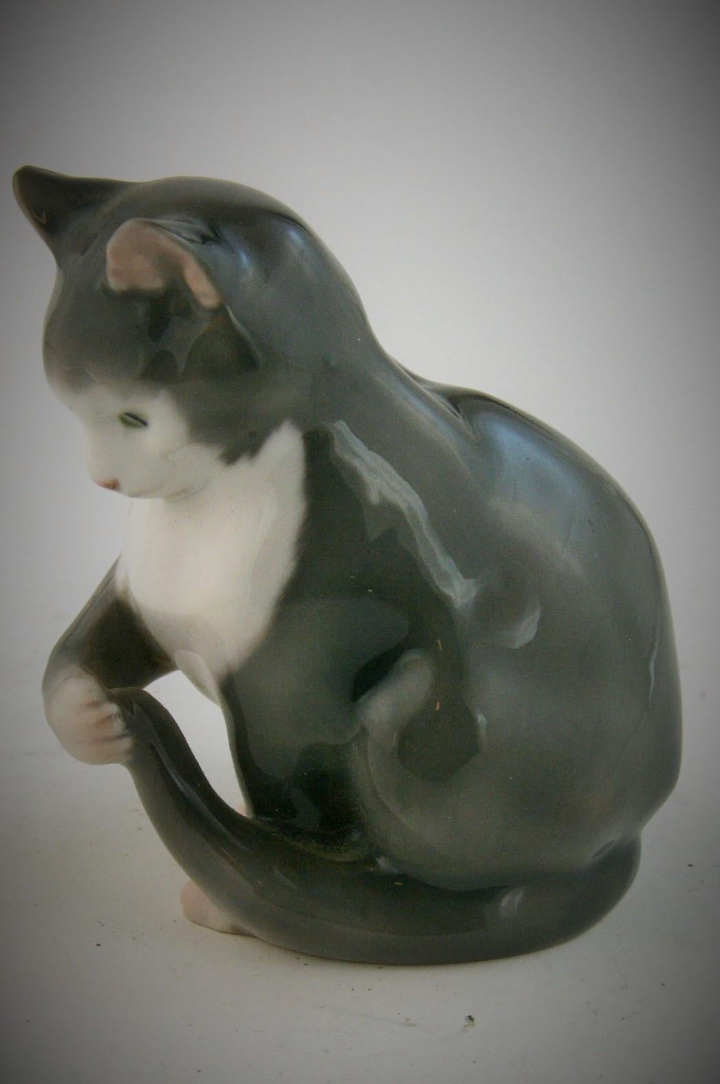 8-253 B and G Danish miniature porcelain cat.
Makers mark with 3  towers of Denmark on bottom.