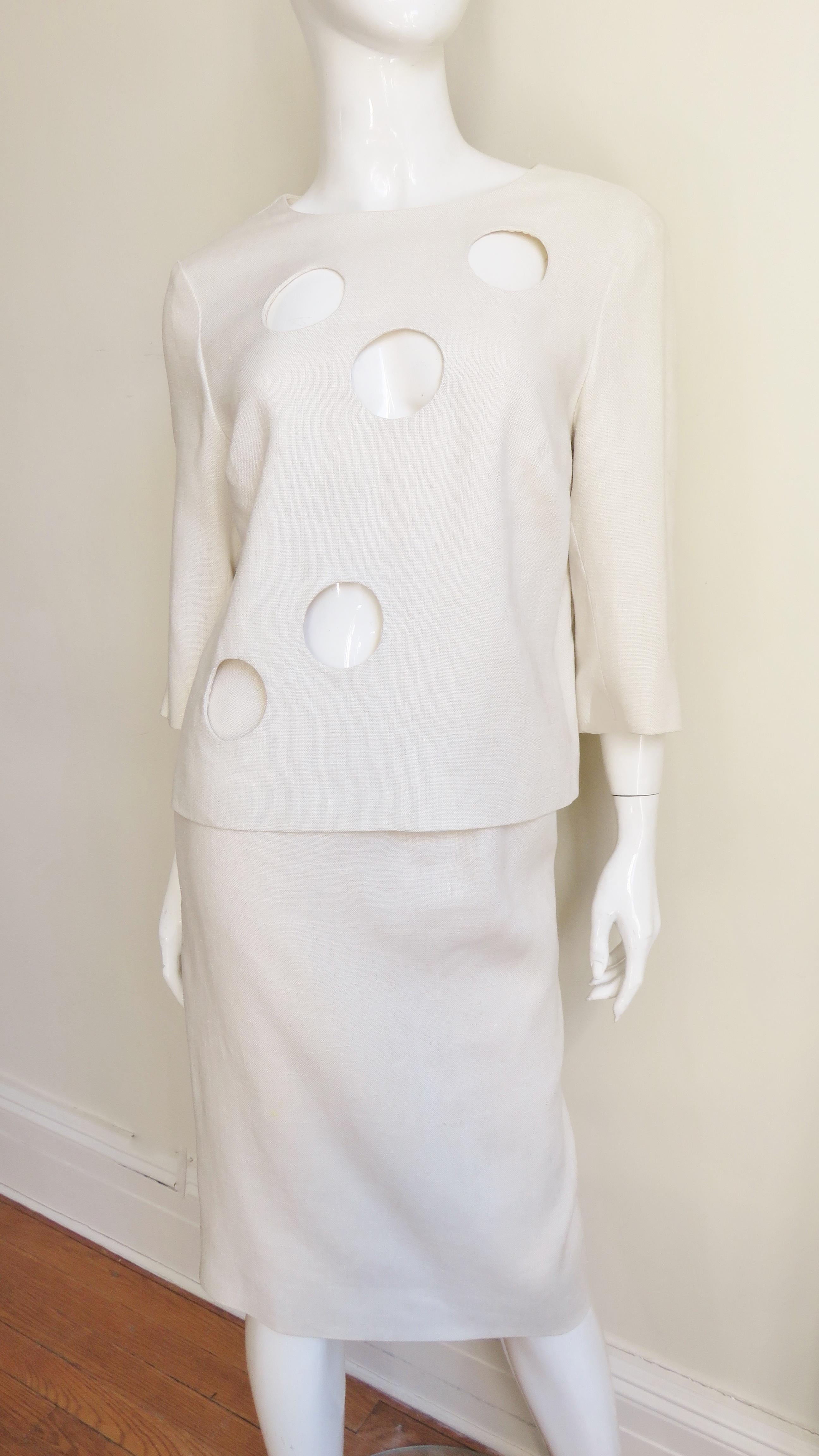 A fabulous off white mid weight linen top and skirt set from B H Wragge dated 1964 on the label. The hip length top has a crew neckline, 3/4 sleeves, a back zipper closure and fabulous circle cut outs on the front. The straight skirt has a waistband