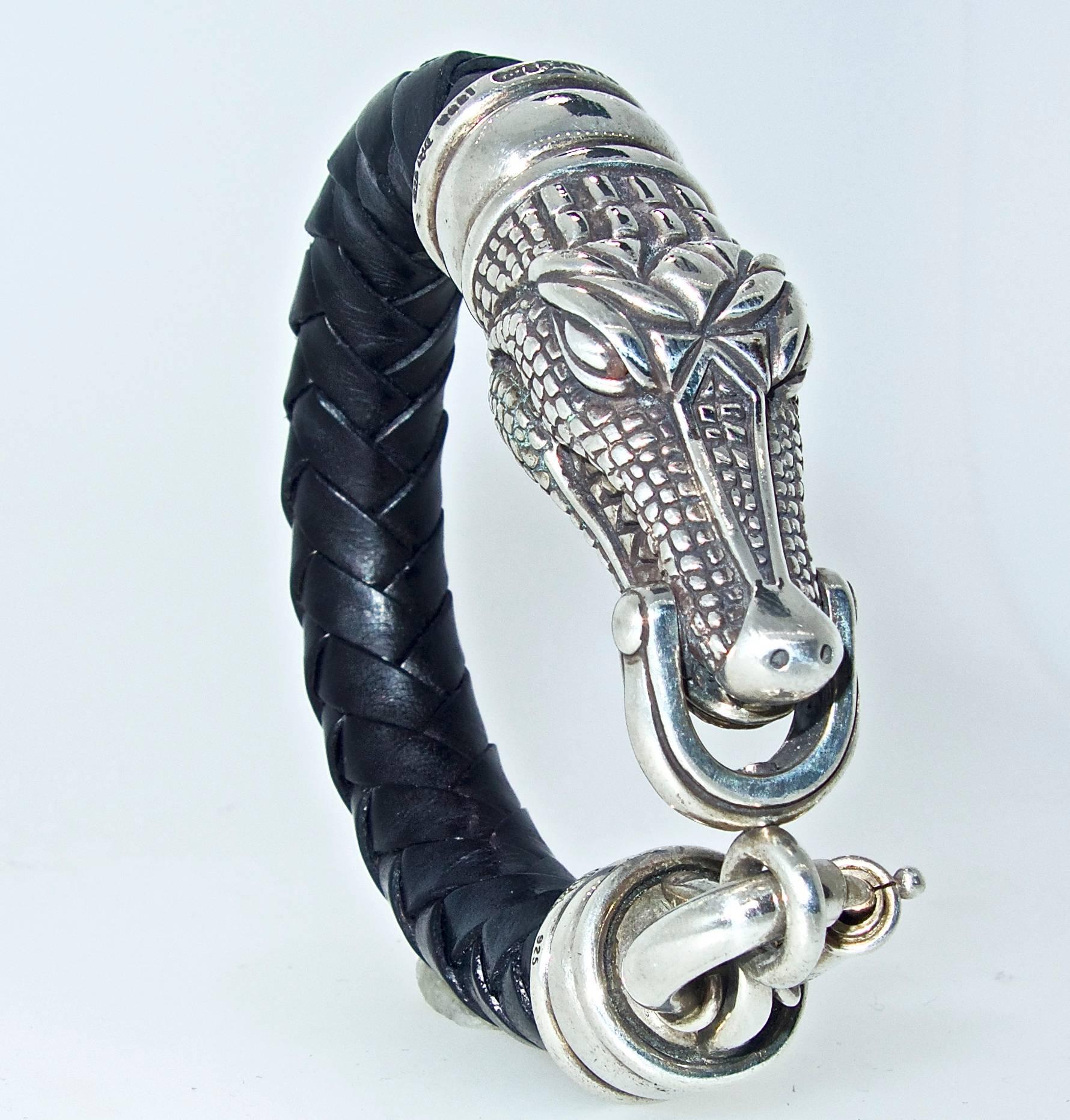 Sterling silver and braided leather alligator motif bracelet by B. Kieselstein-cord.  The interior dimension is 7.25 inches.  Signed with the year 1993, and their moon and star logo and 925 for sterling silver.  This bracelet will fit most wrists.