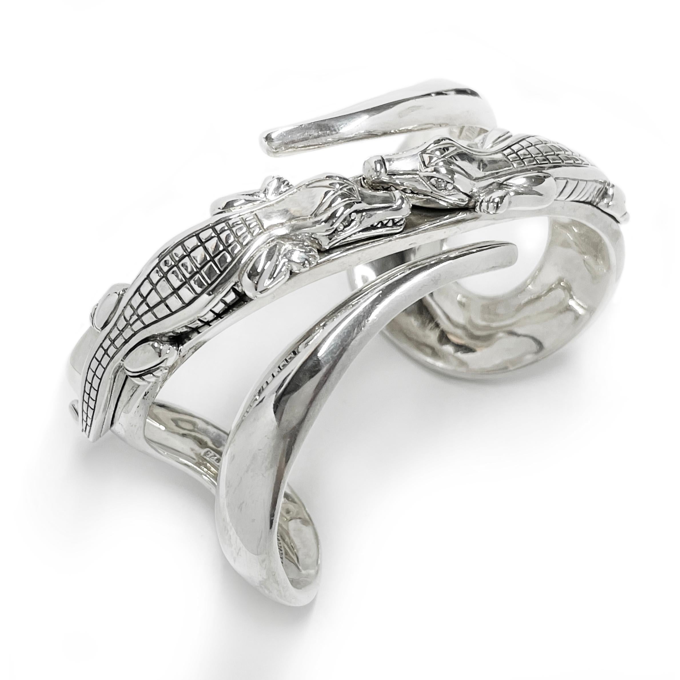 B. Kieselstein Cord Silver Alligator Diamond Cuff. This statement cuff features two facing alligators on the top of the cuff and curved tail-like swooshes. Four 1.8mm round diamonds are set in the eyes of the alligators for an added accent. The