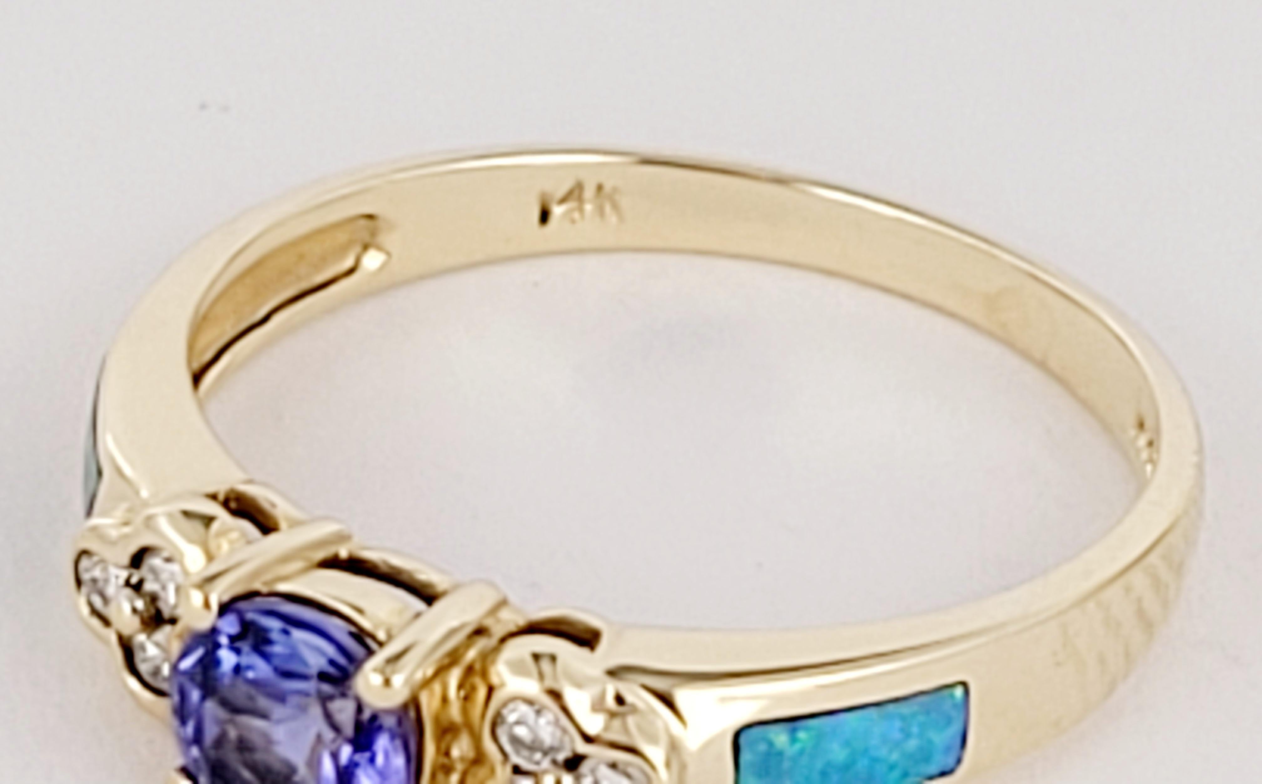 Vintage B&M designed ring with a Tanzanite center stone;
accented with diamonds and opal inlays set in solid yellow gold.

Weight: 2.2 grams
Size: 7.25
Materials: 14k yellow gold, Tanzanite, diamonds, Opal Inlay
Stone Tanzanite: 4.7 x 4.7 and  6 pcs