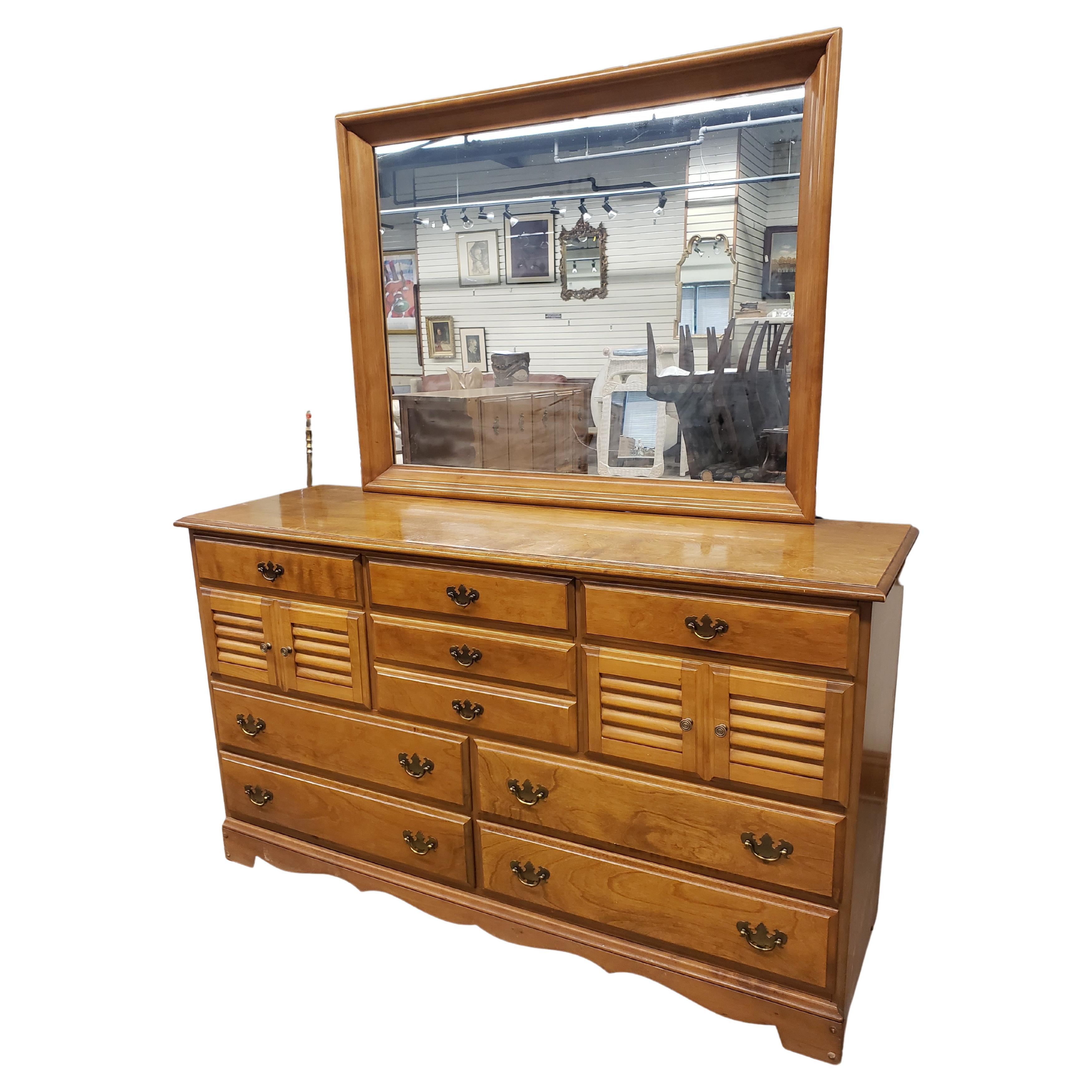 A 1960s BP John maple dresser in very good vintage condition. Measures 60 inches in width, 19 inches in depth and 34.5 inches tall without mirror, 69.5 inches tall with mirror. Mirror is 45 inches in width and 35 inches in height. And 2.75 inches in