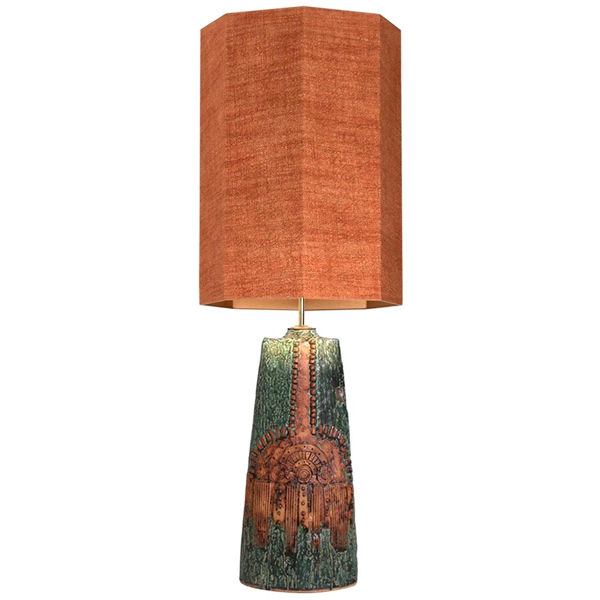 A rare ceramic table lamp by Bernard Rooke, England, 1960s. A sculptural piece, made of handmade ceramic elements in natural tones of terracotta and stone. With a special custom made silk lamp shade with warm gold/bronze inner-shade by René