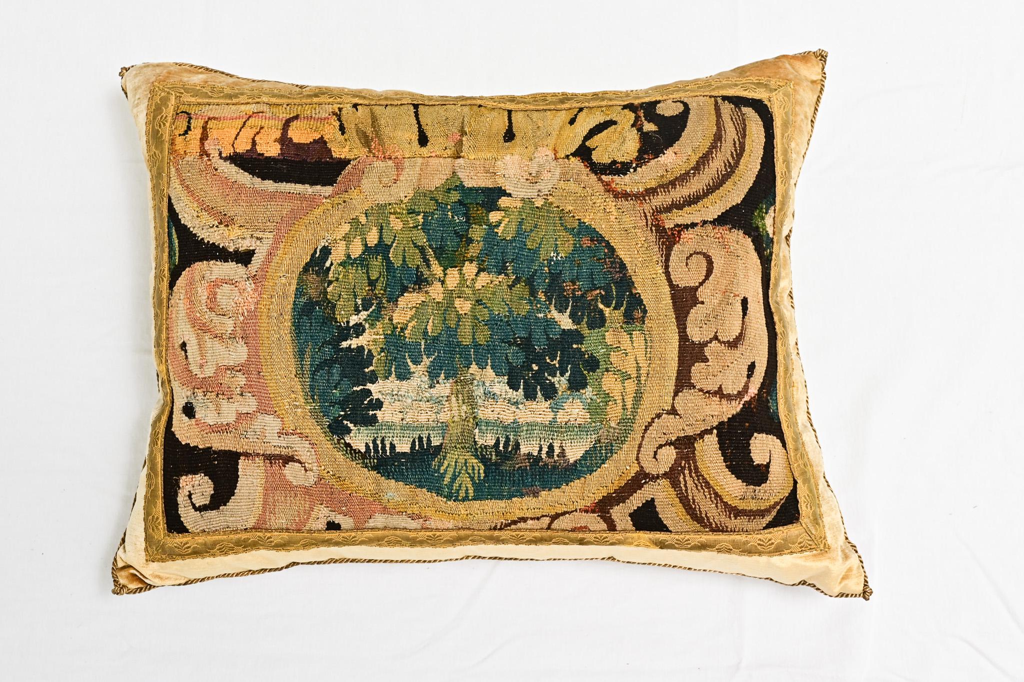 A single 18th Century tapestry fragment and velvet pillow. Hand trimmed and features vintage gold metallic cording, knotted in the corners. Designed by Rebecca Vizard for B. Viz Design. This down filled pillow makes a statement with an 18th Century