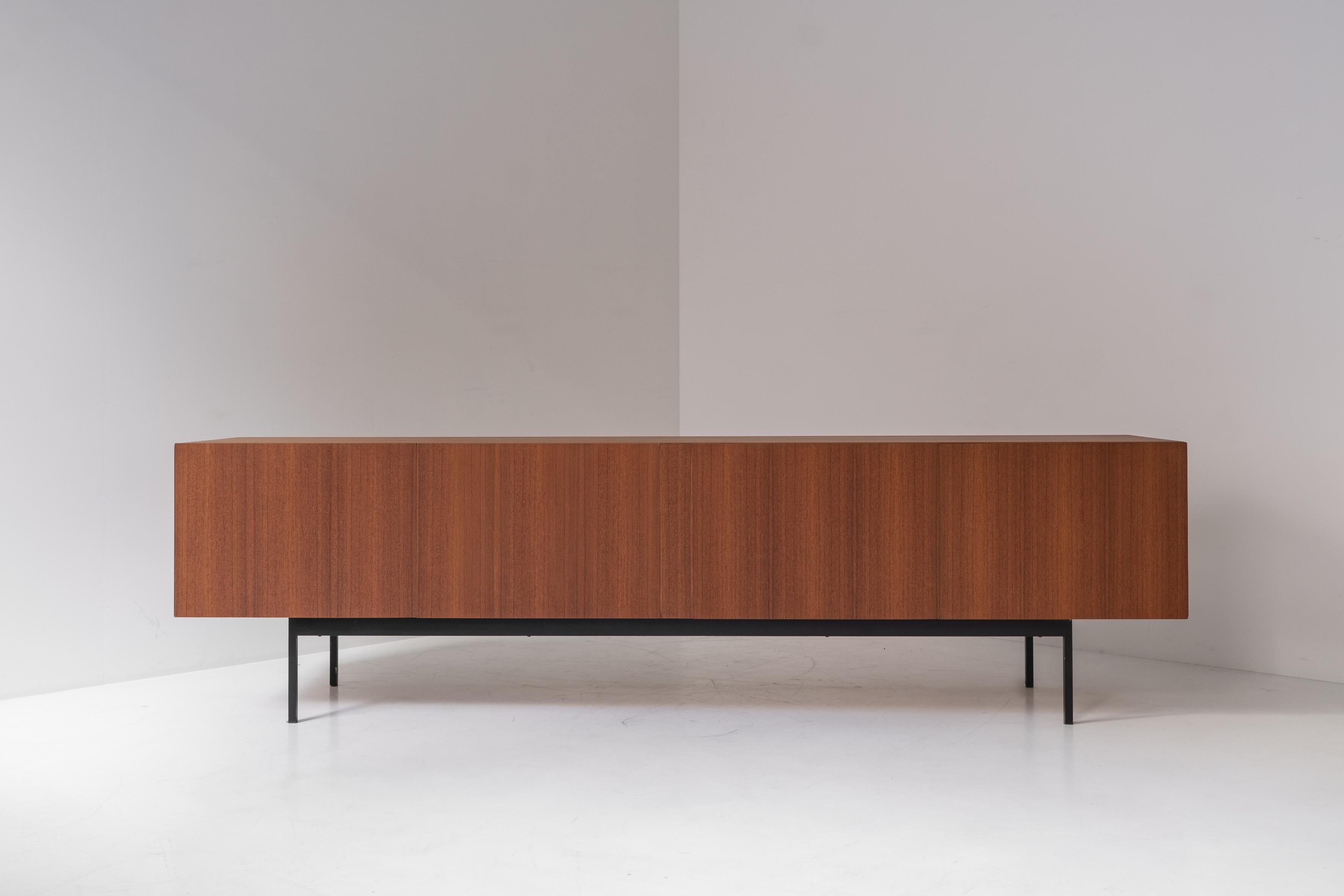 Minimalist ‘B40’ sideboard by Swiss architect Dieter Waeckerlin for Behr Möbel, Germany 1958. This sideboard is made out of teak and has a black lacquered steel frame. The inside is finished with maple wood removable trays and a bottle holder.