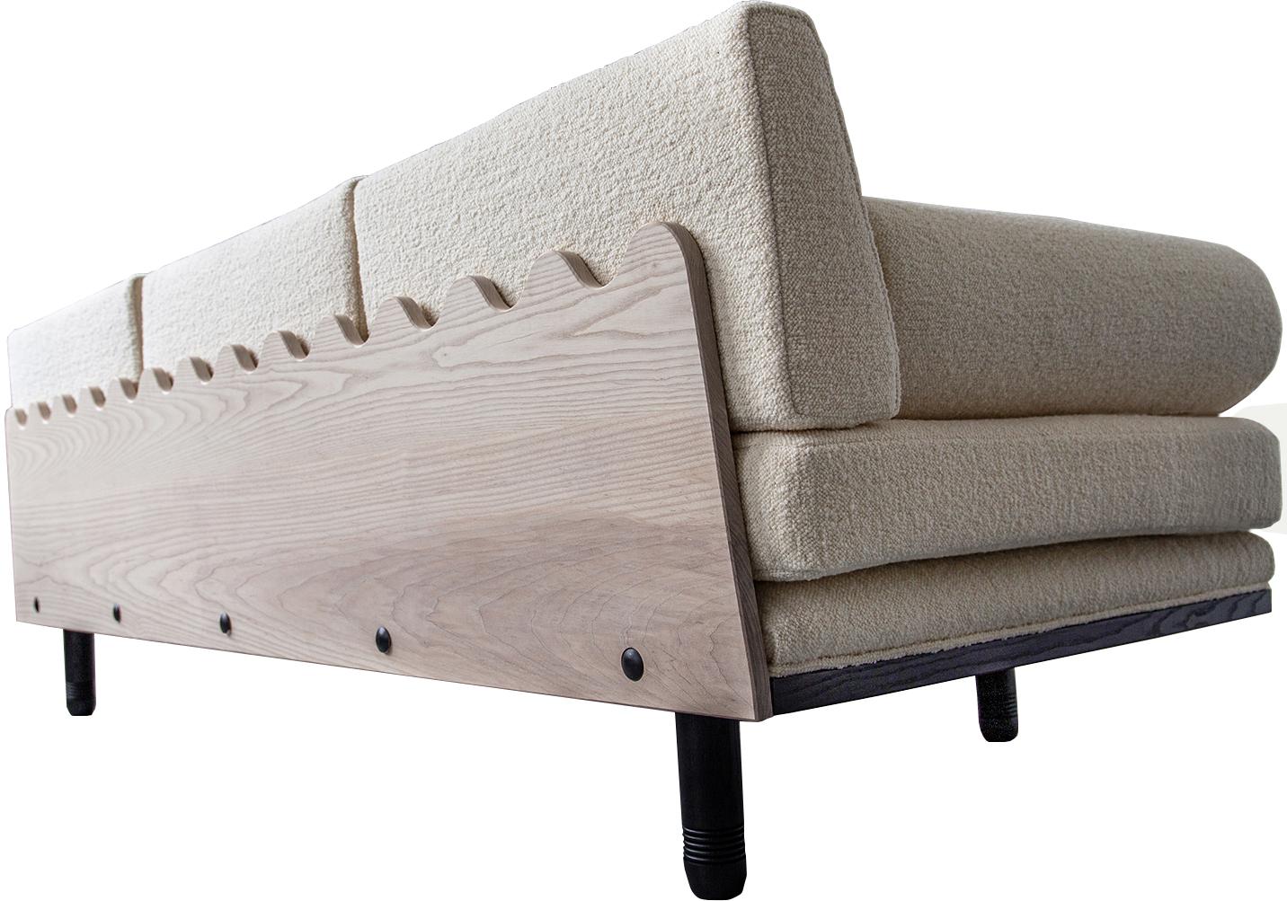 A decadent three-seat sofa daybed of sculptural trapezoidal form inspired by the fallen architectural ruins of the ancient city of Baalbek, a levantine outpost on the Roman frontier. Featuring plinth bolsters, removable arched back support and deep