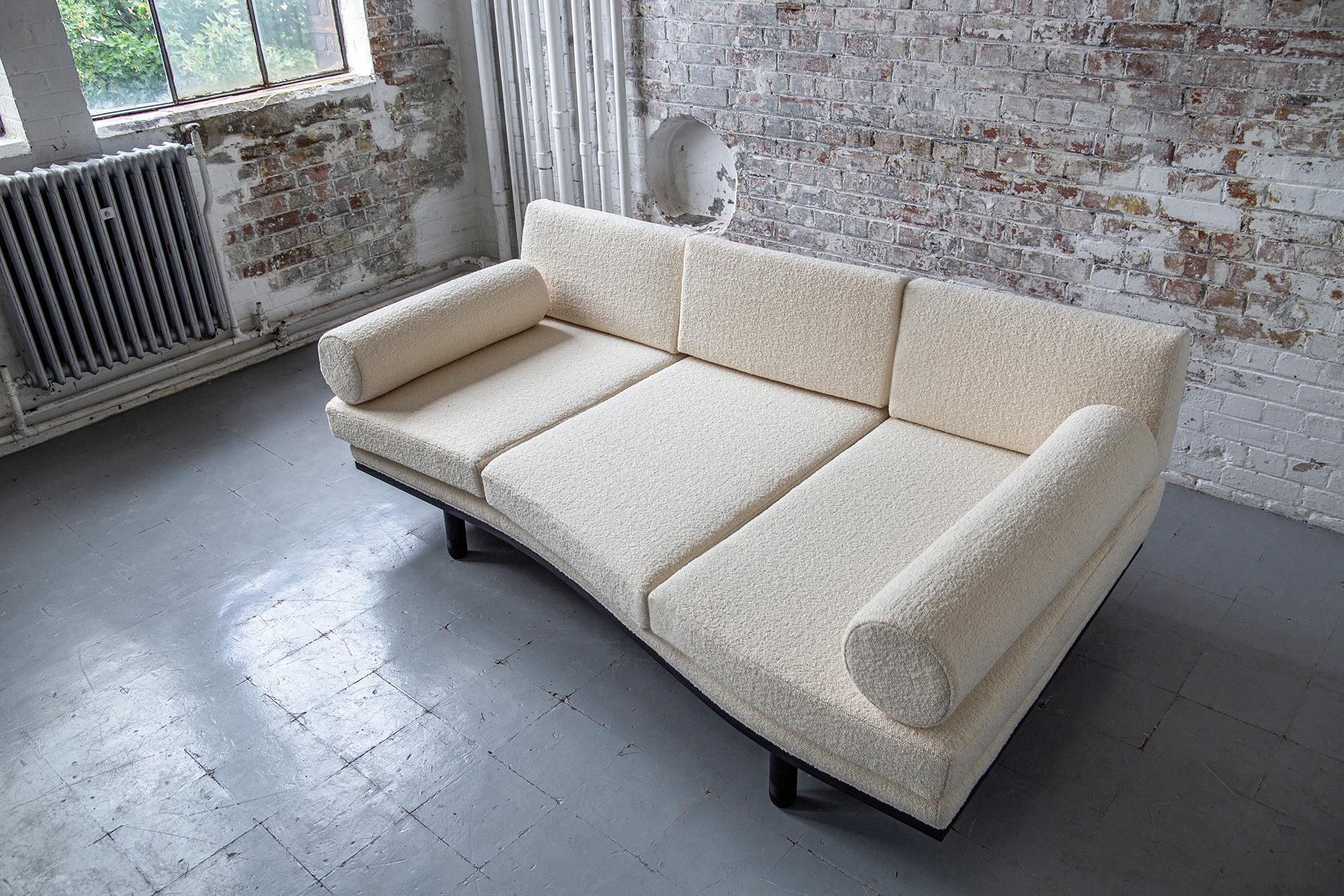A decadent three-seat sofa daybed of sculptural trapezoidal form inspired by the fallen architectural ruins of the ancient city of Baalbek, a Levantine outpost on the Roman frontier. Featuring plinth bolsters, removable arched back support and deep