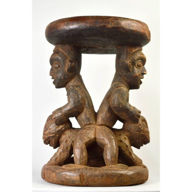 Babanki Janus Stool in Wood

Wood-carved stool with a pair of classic Babanki figures sitting astride a Janus leopard image. This object dates to the 1950s and was part of a cache of African wood carvings found in the rear of a Manhattan warehouse