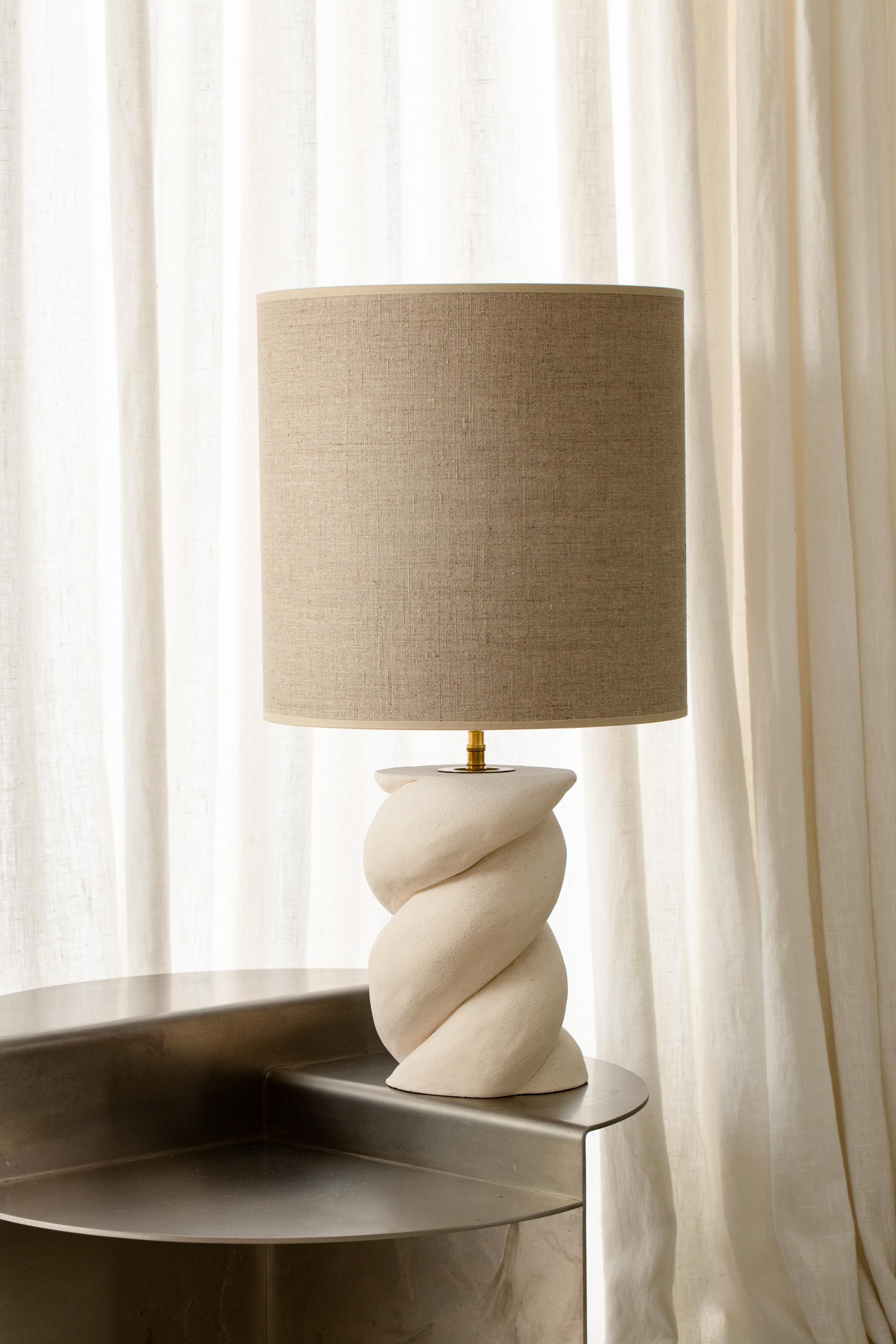 Babka Table Lamp by Di Fretto
Dimensions: ⌀ 14 x H 53 cm (measure without lampshade)
Materials: White Faience (not glazed)

The Babka table lamp is a twist in white earthenware. Representation of life, it evokes the twist of DNA.

The lampshade is a