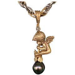 Baby Angel in Yellow Gold on Tahitian Pearl Playing Instrument