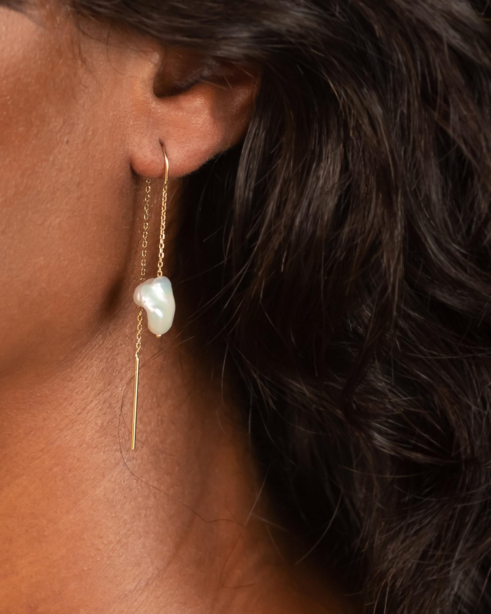 We've paired adorable baby baroque pearls with recycled 14k gold for a great earring that works just as well with a tee shirt as it does with a skin-baring slipdress.  The lightweight chain and gold bar threads comfortably through the ear, and