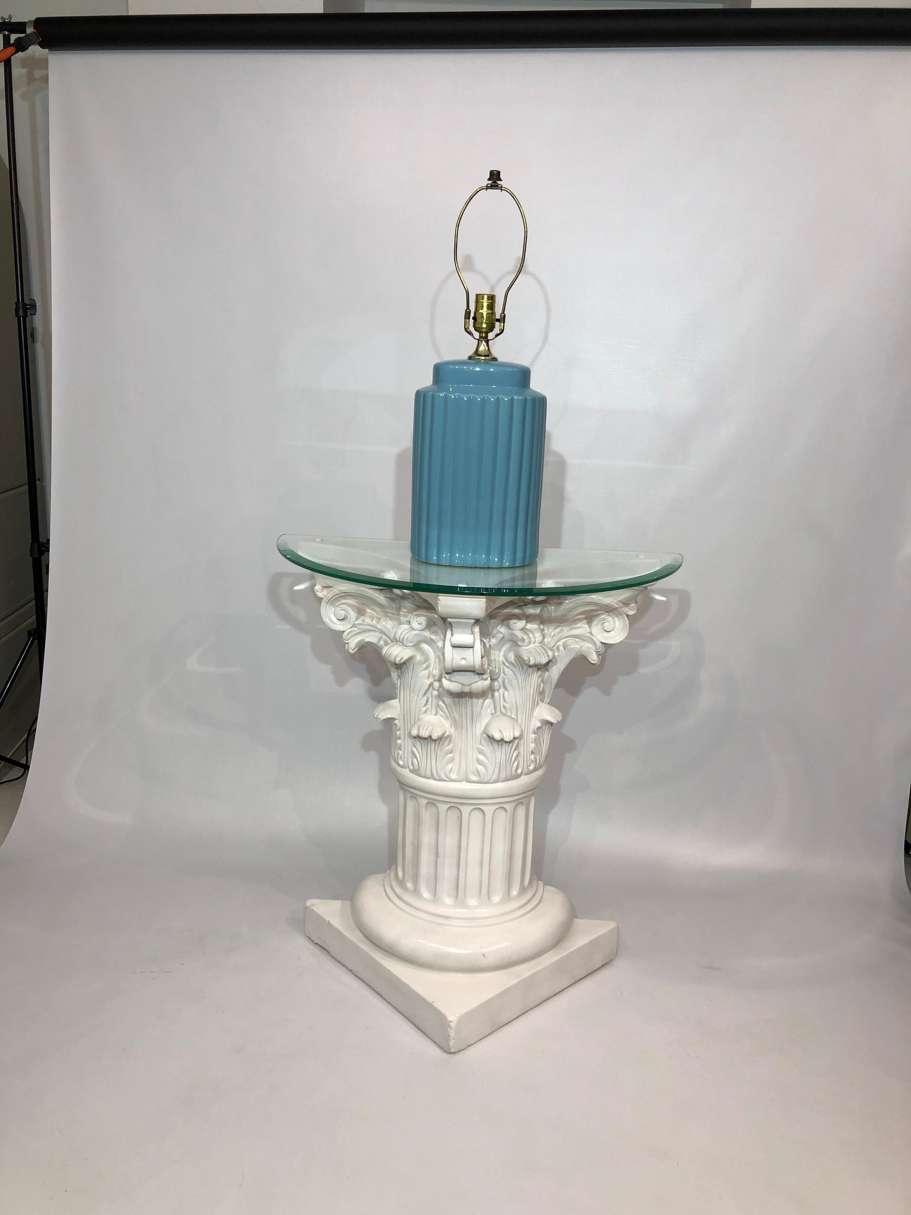 A baby blue-coloured table lamp, with an Art Deco style, in a wonderful wavy ceramic. The nod to the Golden Girls-era 1980s; elegant collumn-like pattern; and pastel colouring of the lamp body means it would look perfect in interiors vintage or