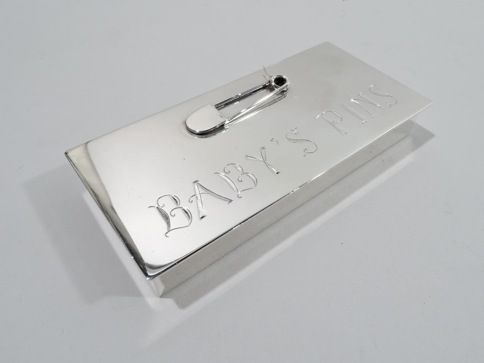 Baby Boom-era sterling silver diaper pin box. Rectangular with straight sides and sharp corners. Cover flat, hinged, and overhanging. On cover top is applied safety pin above engraved words “Baby’s Pins”. A sweet memento of postwar fecundity. Marked