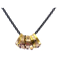 "Baby Boom" Necklace with Eleven Gold Antique American Baby Rings on Black Chain
