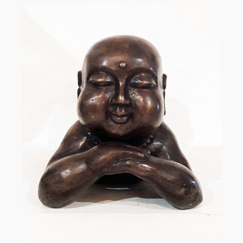 A bronze statue of a baby Buddha in sleeping position. From Indonesia. Available in polished bronze and bronze with patina finish.