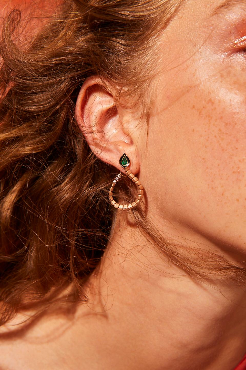 Dragon Lady Collection is inspired by the fire element which is one of the elements that represents our life energy. The main form of the collection is dragon; it is the symbol of strength, courage and prosperity. 

Baby dragon emerald hoop earrings