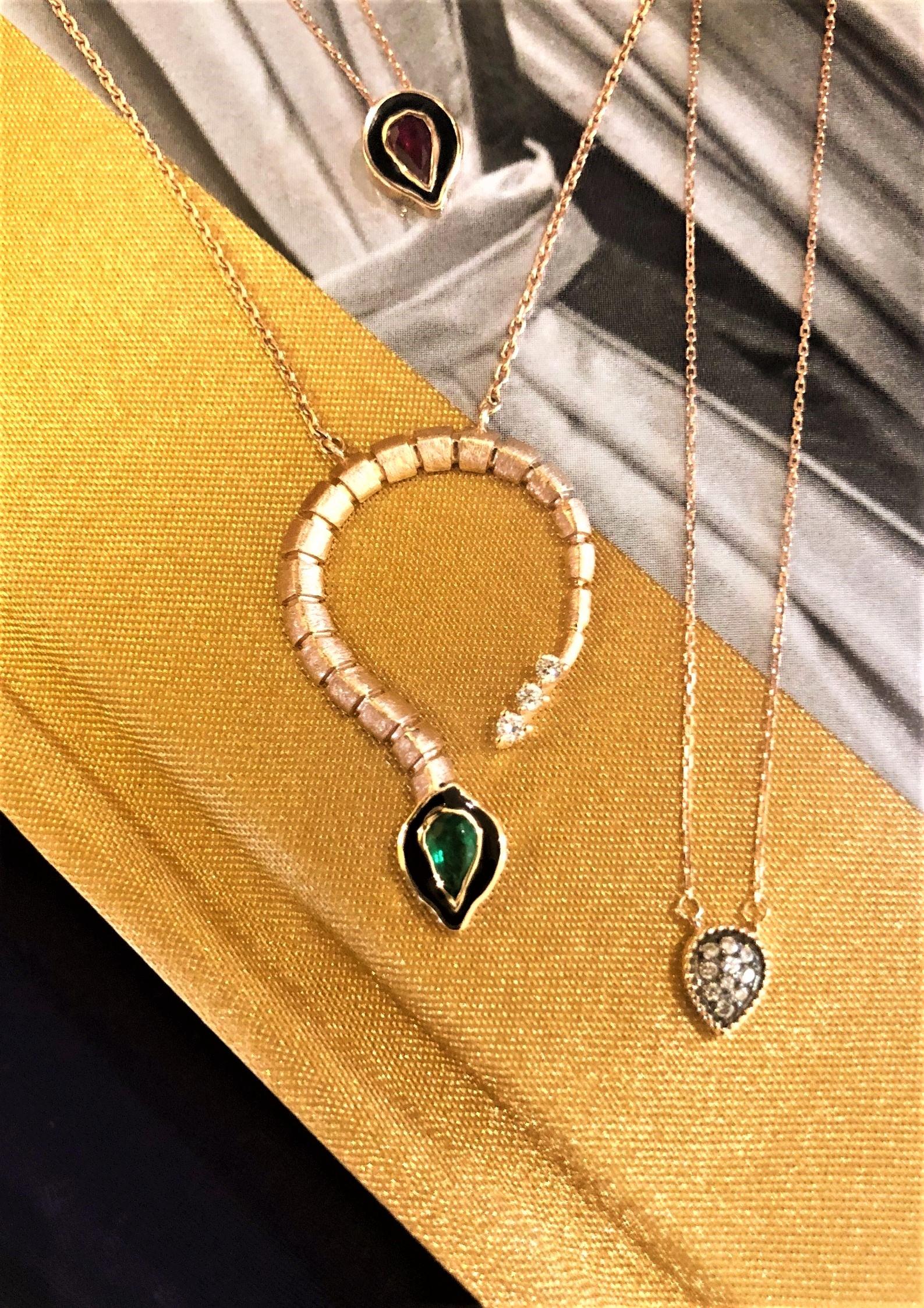 Baby dragon necklace in 14k rose gold with 0.21ct emerald by Selda Jewellery

Additional Information:-
Collection: Dragon lady collection
14K Rose gold
0.06ct White diamond
0.21ct Emerald
Pendant height 3cm
Chain length 45cm