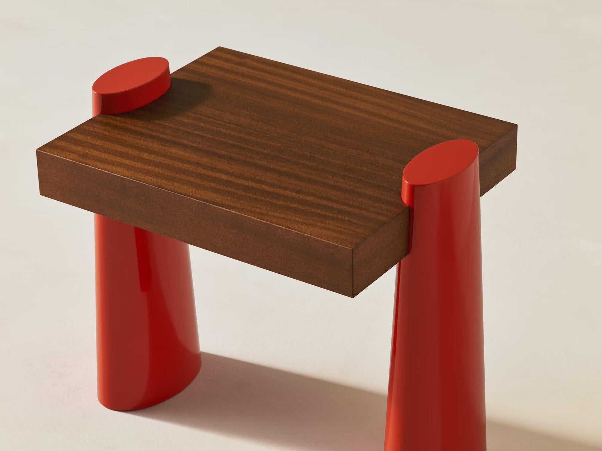 Classic design meets peppy color in the Baby E Side Table. Its rounded, flame-red legs (inspired by baby elephants) offset the rich mahogany seat beautifully, adding a pop of fun to any room.

Additional information:
Material: Mahogany Classic