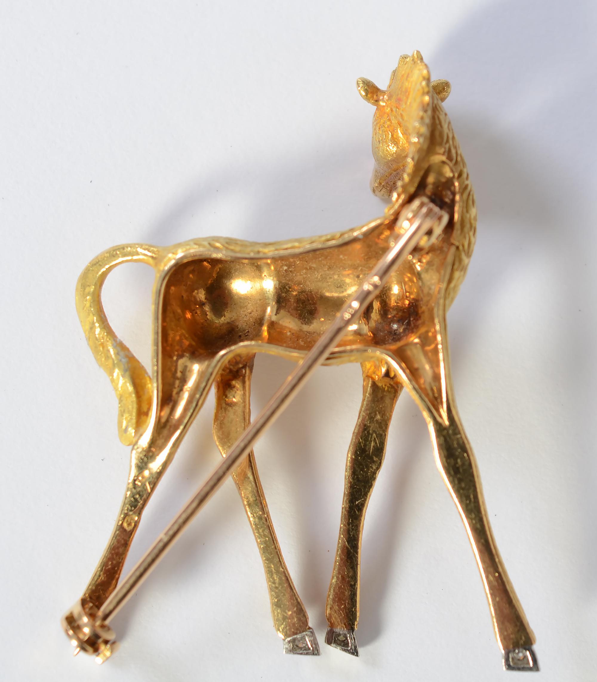 Beautifully detailed 18 karat  brooch of a baby giraffe. It has multiple textures representing the body; tail and mane Each hoof has a diamond. The brooch measures 1 3/4 inches tall and 1 1/4 inches wide. French hallmarks.