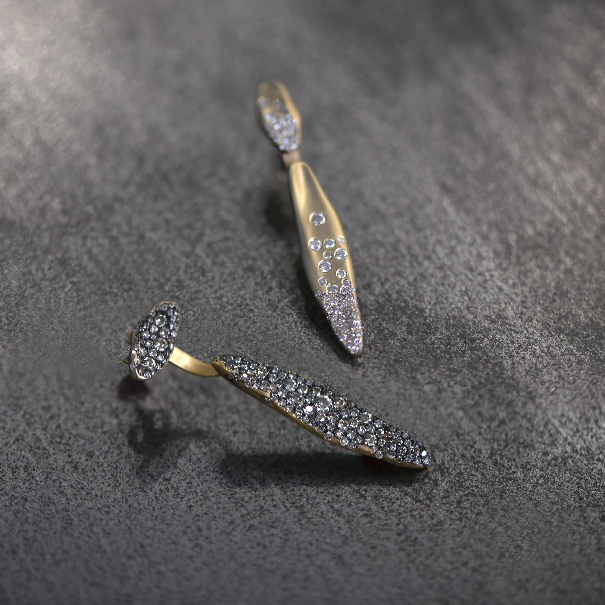 Baby Malak Flourish Earrings transform your look from day to night with a lobe piece and handing drop. The earring is handcrafted in 18K gold and studded with 3CT of champagne diamond. A rhodium finish makes the diamonds bubble like champagne