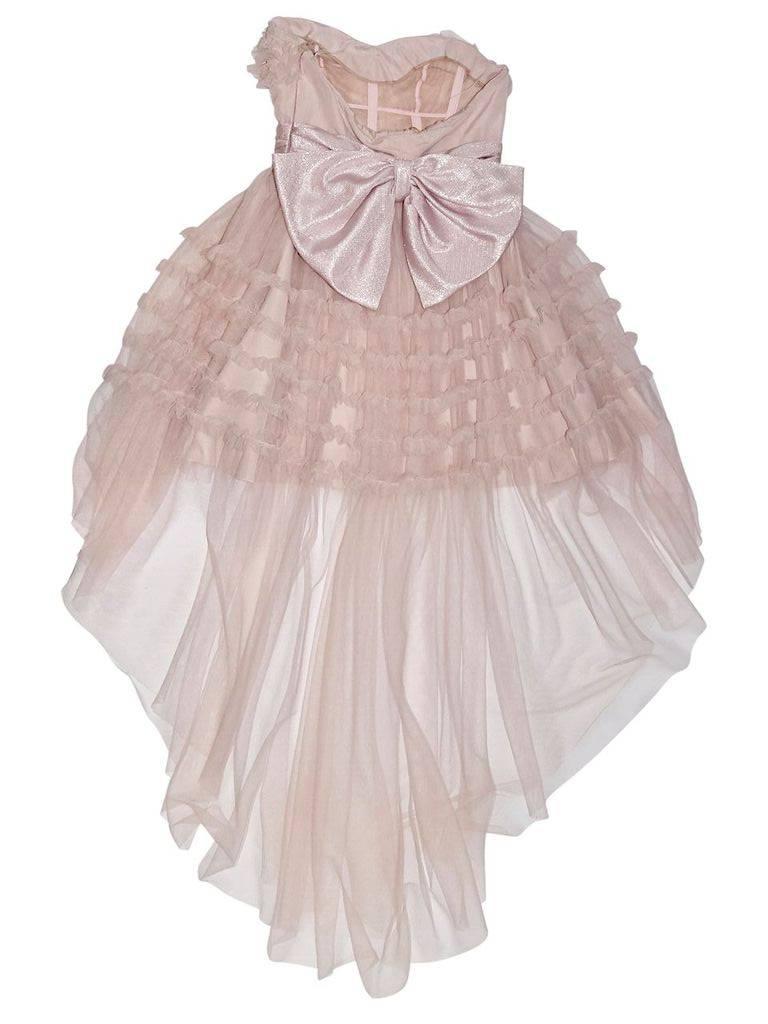 Product details:  Baby pink ruffled tulle strapless dress by Saint Laurent.  Sweetheart neck.  Empire waist.  Concealed side zip closure.  Inner corset support.  Oversize bow at back.  30