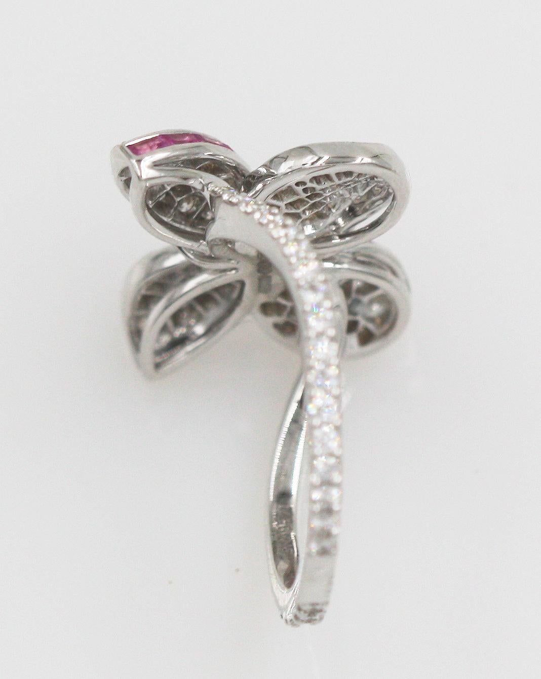Ring Size: 49; US: 4.75 (this ring can be resize by Boutique)
22 Tapered Baguette Pink Sapphires weighing approx. 0.31 Carats.
127 Round Diamonds weighing approx. 0.64 Carats. Fine White. Clarity: VS+
5 Round Purple Sapphires weighing approx. 0.06
