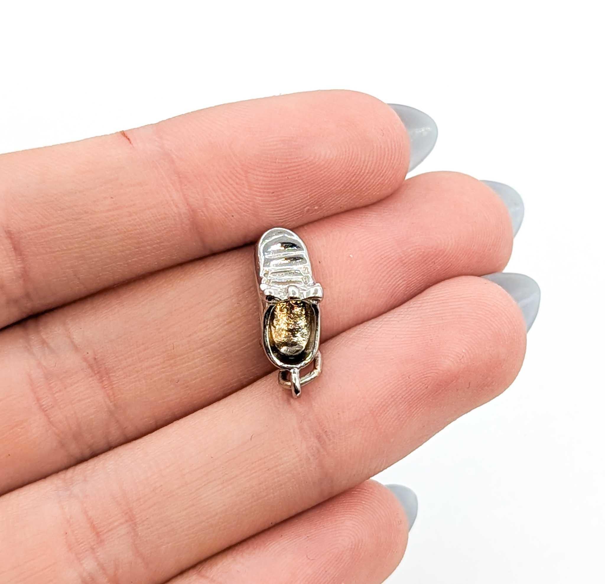 Charming Baby Shoe Pendant crafted in 14k white gold. This sweet miniature shoe design measures 14.5mm by 6mm and weighs 3.1 grams, making it a delightful keepsake or thoughtful gift. With its finely detailed design and petite size, it can be worn