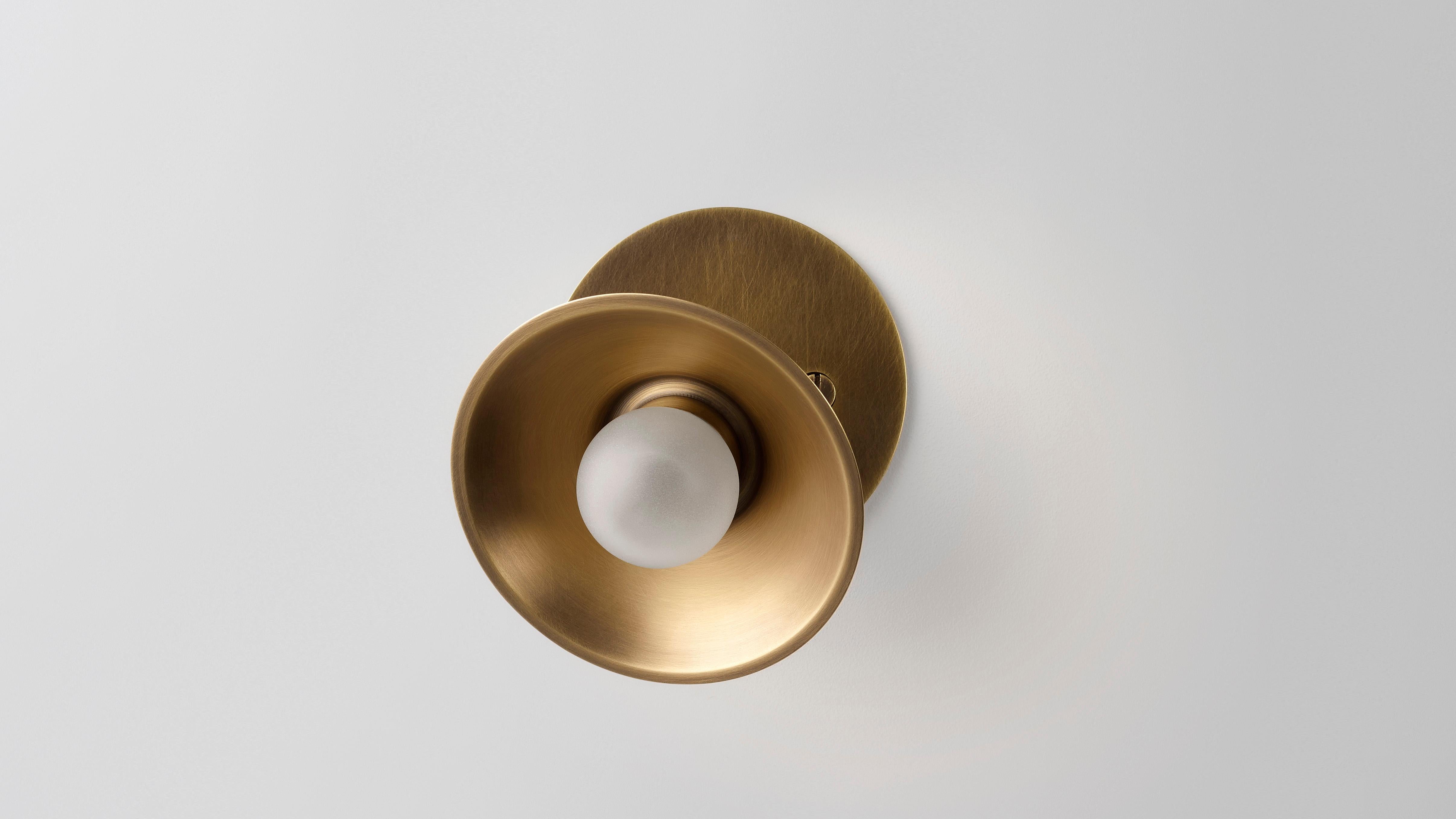 Baby wall swing sconce by Volker Haug
Dimensions: Diameter 10.5 x Height 9.5 cm 
Material: Brass. 
Finish: Polished, aged, brushed, bronzed, blackened, or plated
Light: G4 - 12V, LED x 1
Power supply: 110V-240V, 12V transformer