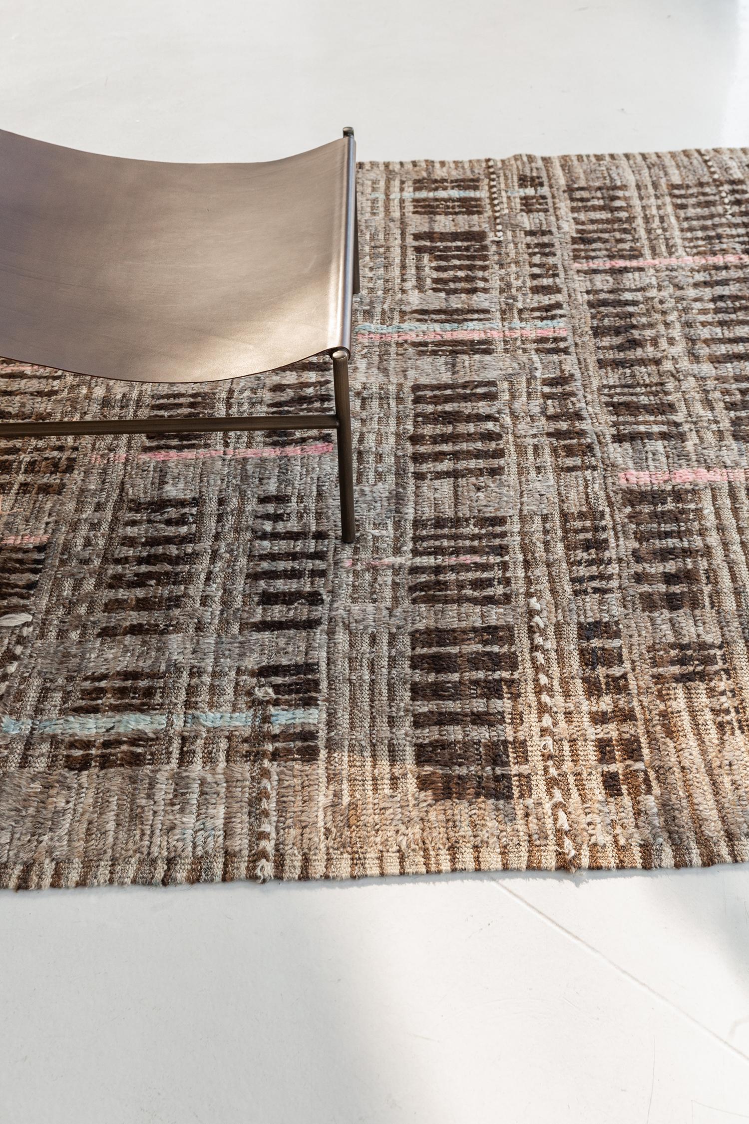 Bacatta uses linework and color to create definition and movement into handwoven wool. Line detailing in taupe and tan fascinatingly move across the rug. Detailed natural flat-weave runs around the border with tassels adding an exquisite decorative
