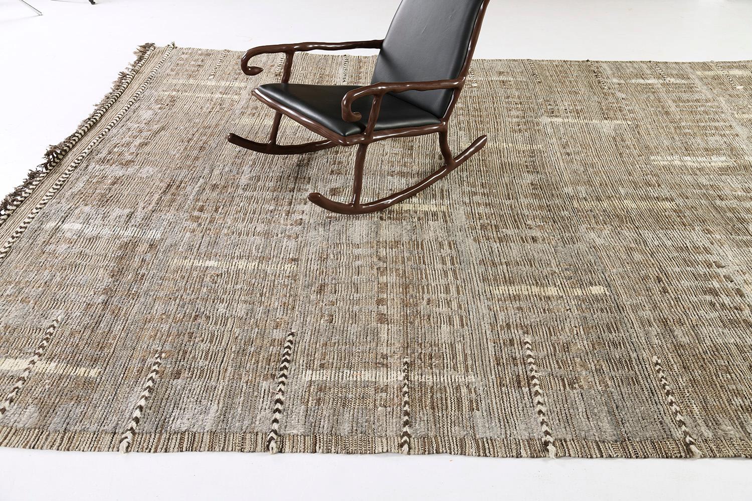 Bacatta uses linework and color to create definition and movement into handwoven wool. Line detailing in earthy tones fascinatingly moves across the rug. Detailed natural pile weave runs around the border with tassels adding an exquisite decorative