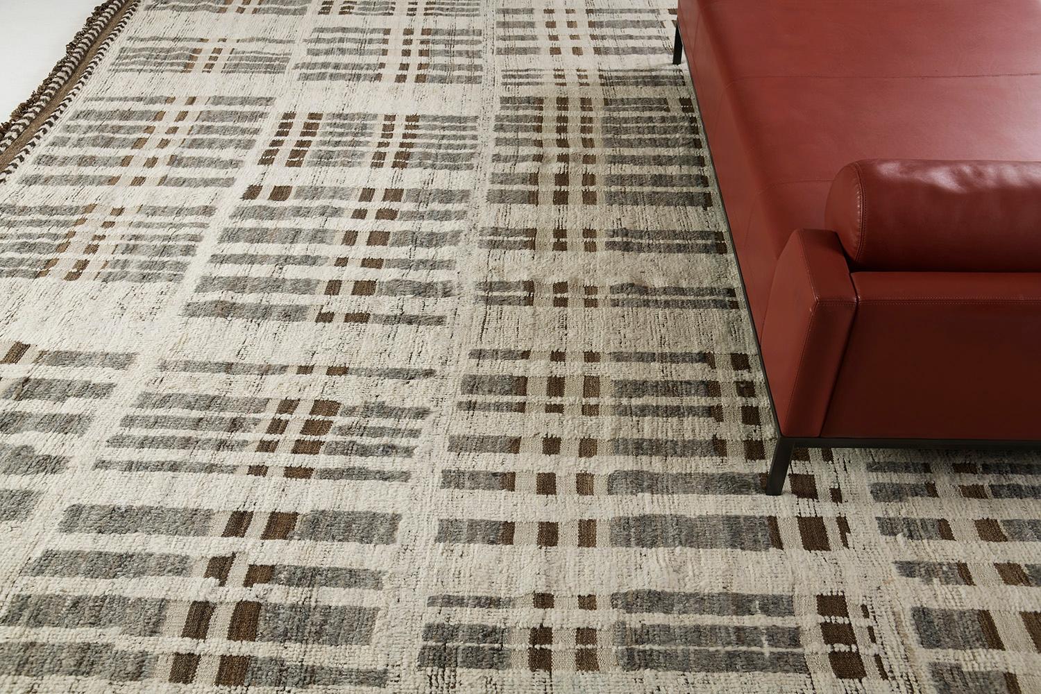 Bacatta uses linework and color to create definition and movement into handwoven wool. Line detailing in the combination of natural gray and brown tones fascinatingly moves across the rug. Detailed natural pile weave runs around the border with