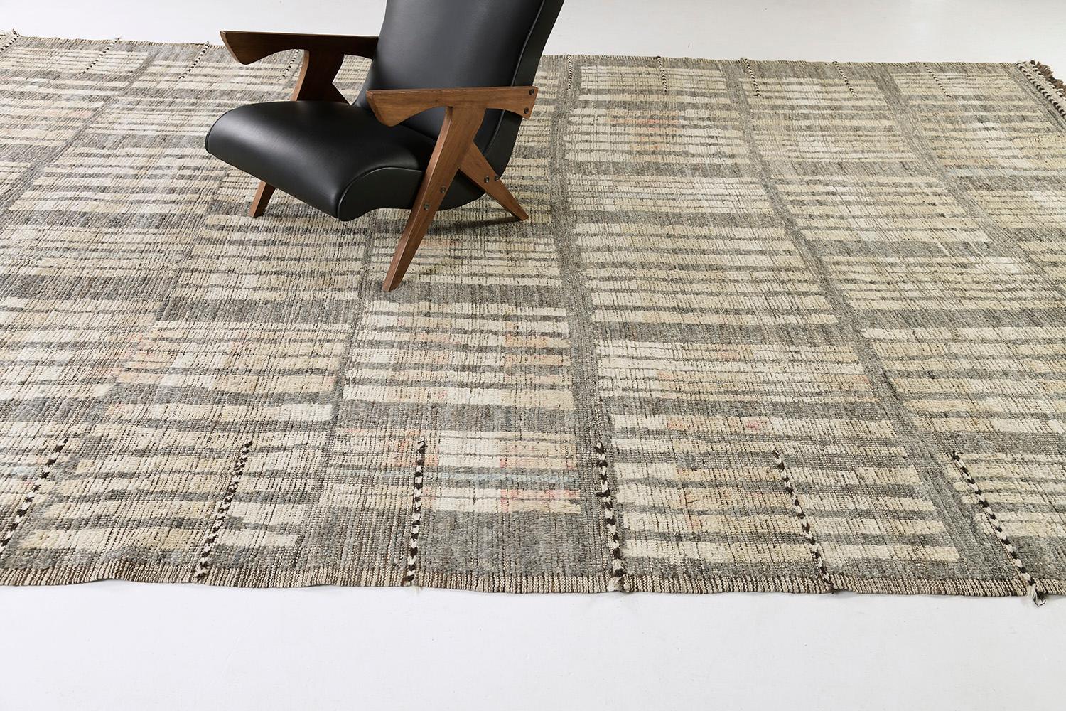Bacatta uses linework and color to create definition and movement into handwoven wool. Line detailing in gray, gold, and brown tones fascinatingly moves across the rug. Detailed natural pile weave runs around the border with tassels adding an
