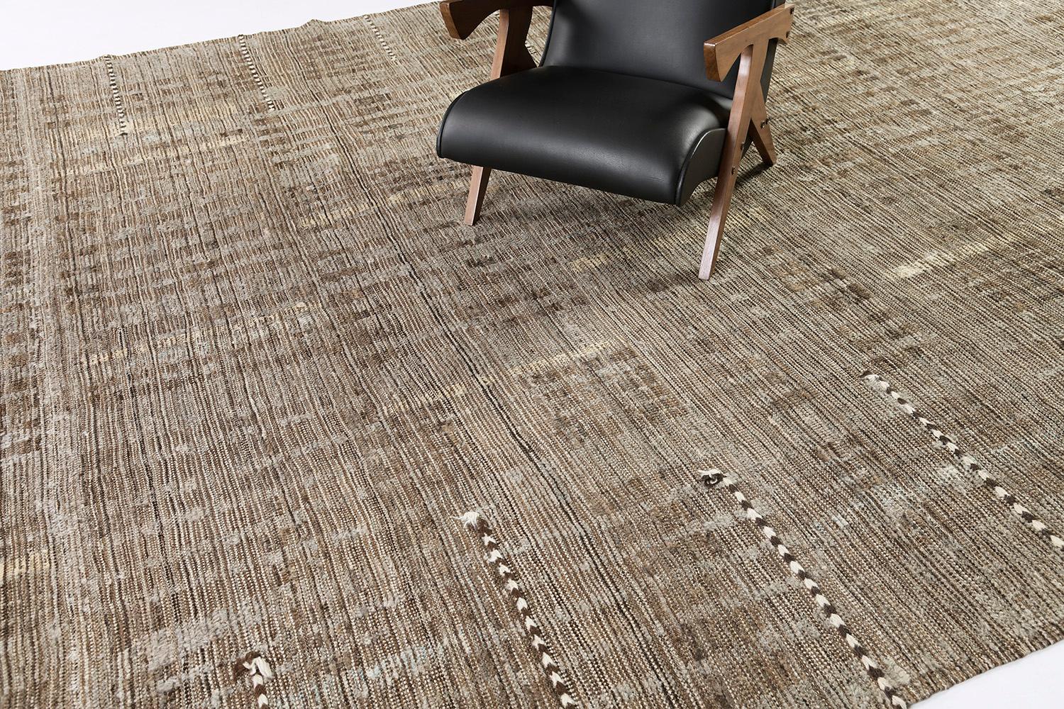 Bacatta uses linework and color to create definition and movement into handwoven wool. Line detailing in neutral tones fascinatingly moves across the rug. Detailed natural flatweave runs around the border with tassels adding an exquisite decorative