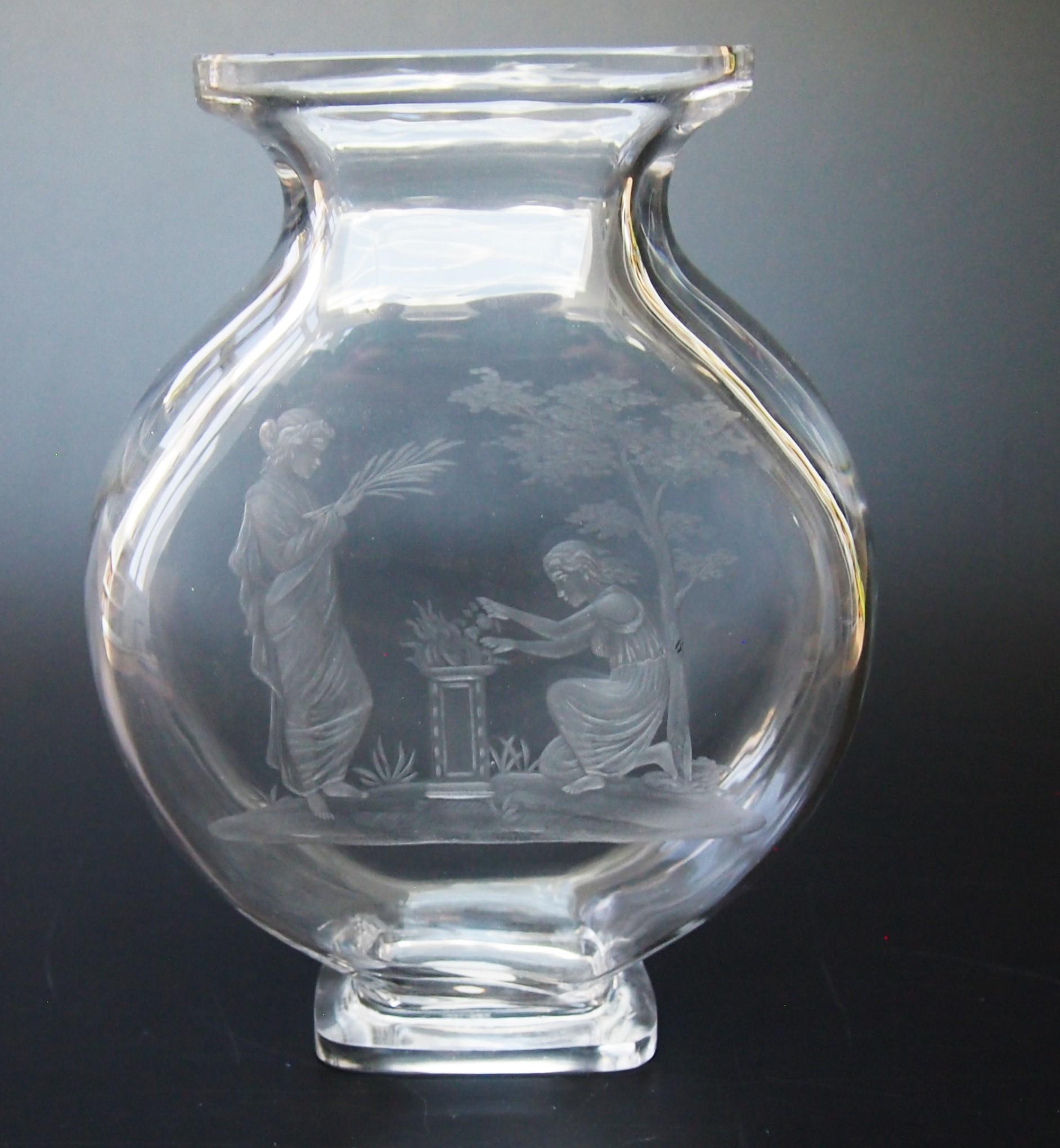 Fabulous, intaglio carved, Baccarat vase in the Aesthetic style dating around 1880. Depicting two classically dressed women arranging fruit and plants on a pedestal with a landscape background with a large finely detailed tree. As usual with such