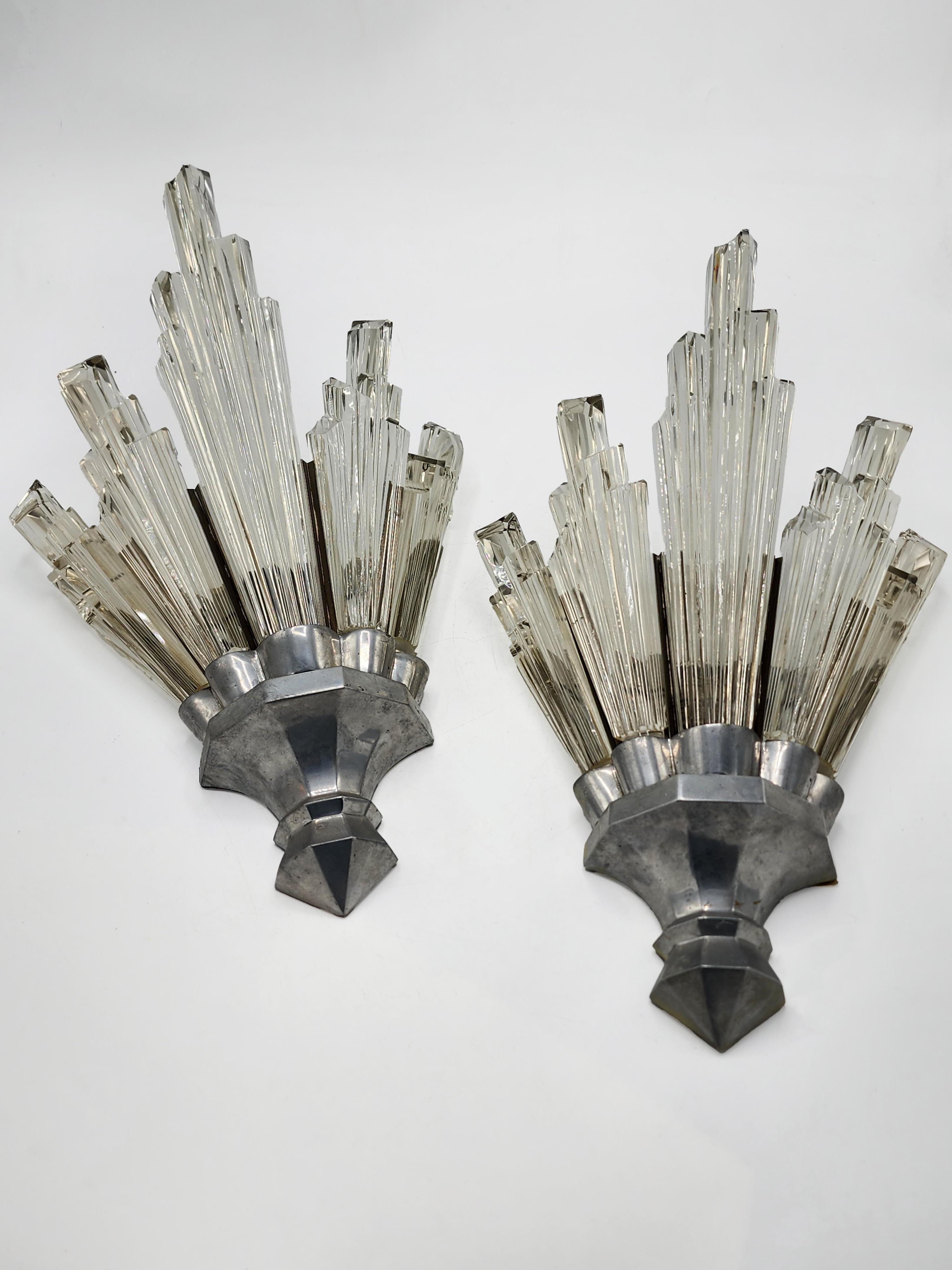 Baccarat Art Deco Crystal Sconces
These sconces feature a distinctive Art Deco design, characterized by a semicircular fan-shaped base, from which emerge multiple crystal rods arranged in an ascending, staggered pattern, emulating the aesthetic of a