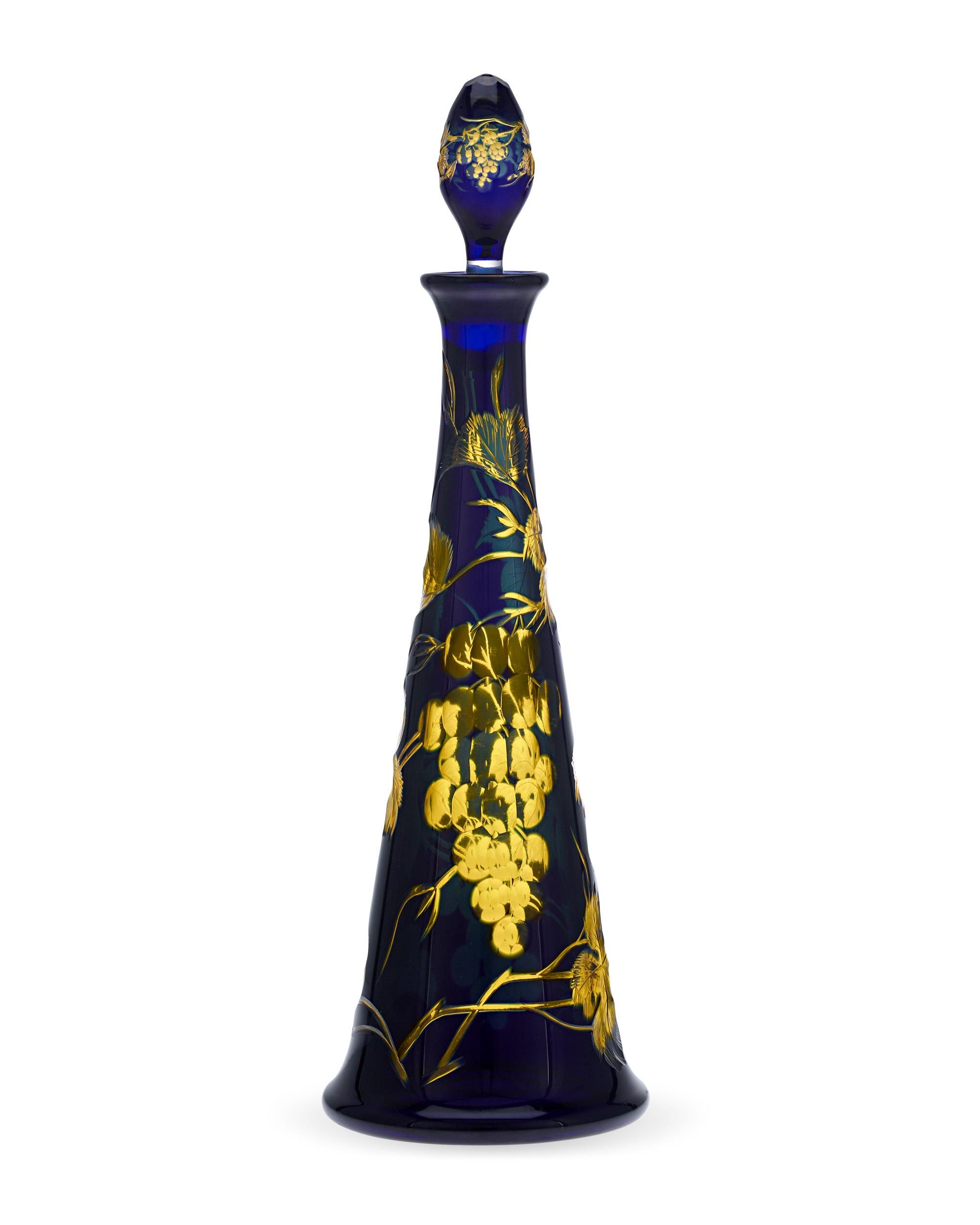 This elegant decanter from celebrated luxury crystal manufacturer Baccarat is a feast for the senses. The interplay of rich yellow and blue cobalt creates a captivating glow from every angle, while the magnificently etched designs of luscious grape