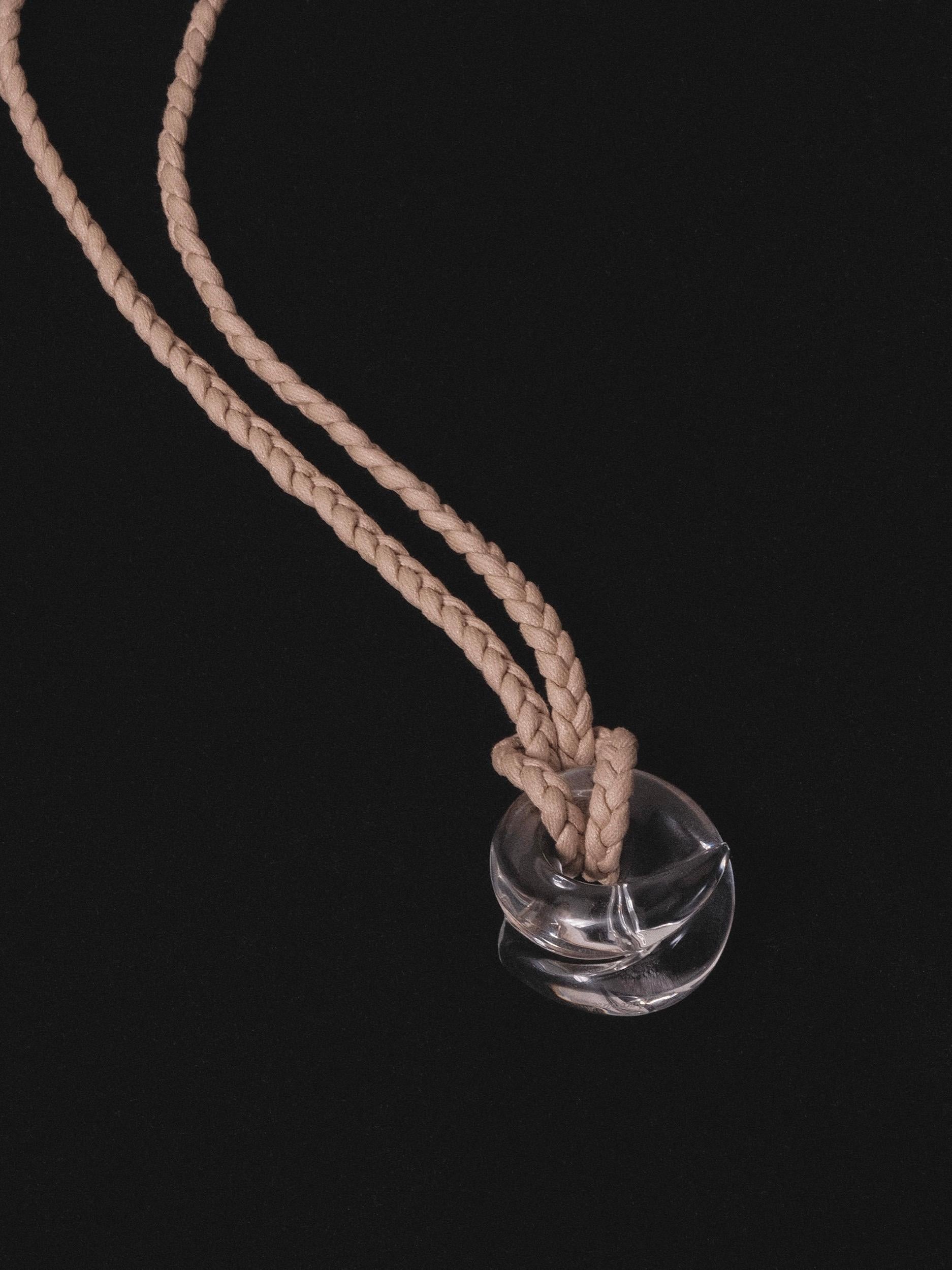 Catherine Noll designed Baccarat Coquillage Necklace
Clear crystal swirl (abstract seashell) on beige cotton braided rope
1995
90 cm / 35 inches adjustable length

Includes dustbag

Documented in 