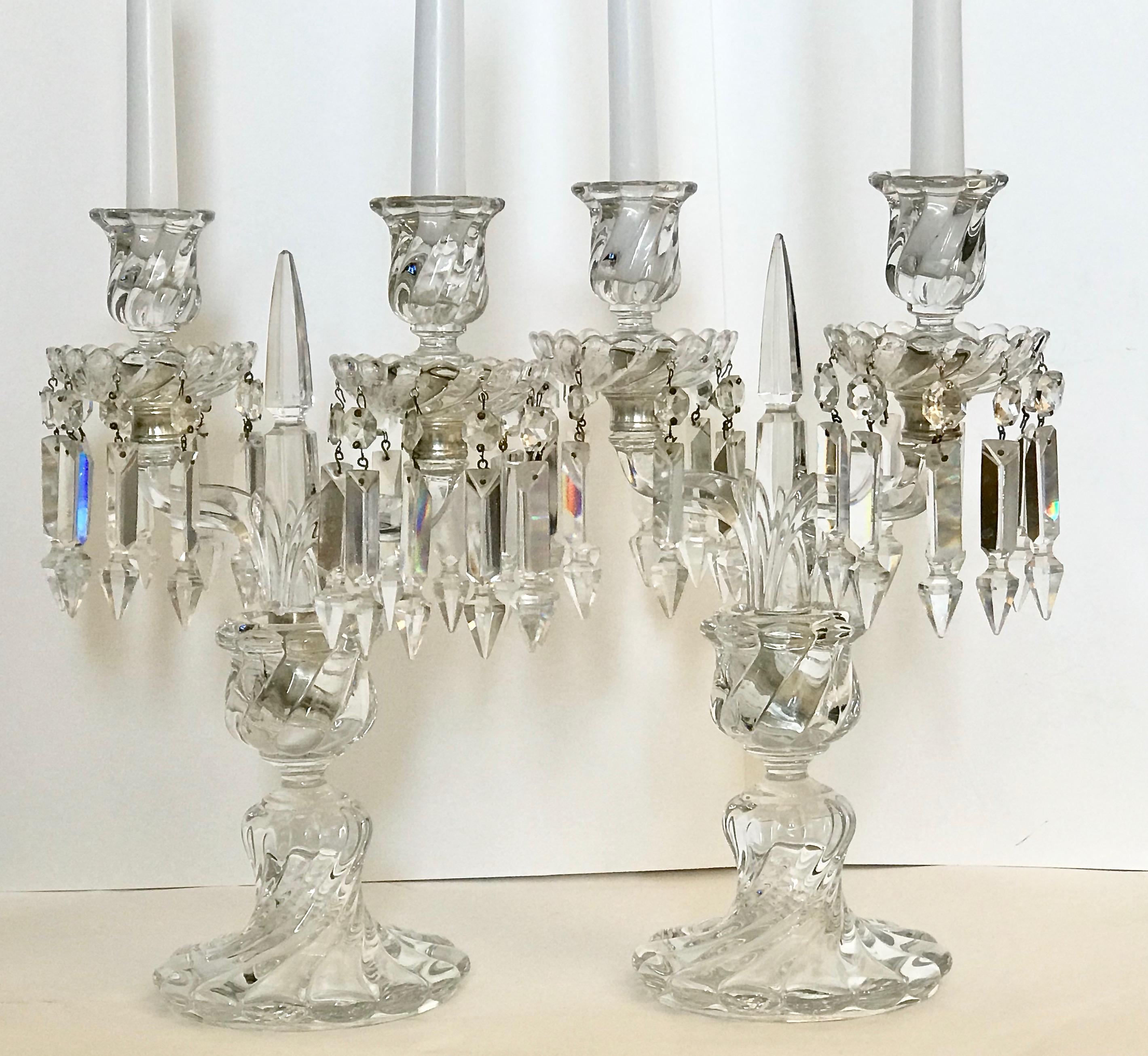 A fine cut crystal pair of candelabras, each with two candlestick arms, cut crystal pendants below the candle cups, raised on a circular bamboo swirl design cut crystal base.
Late 19th century or early 20th century, bamboo model by