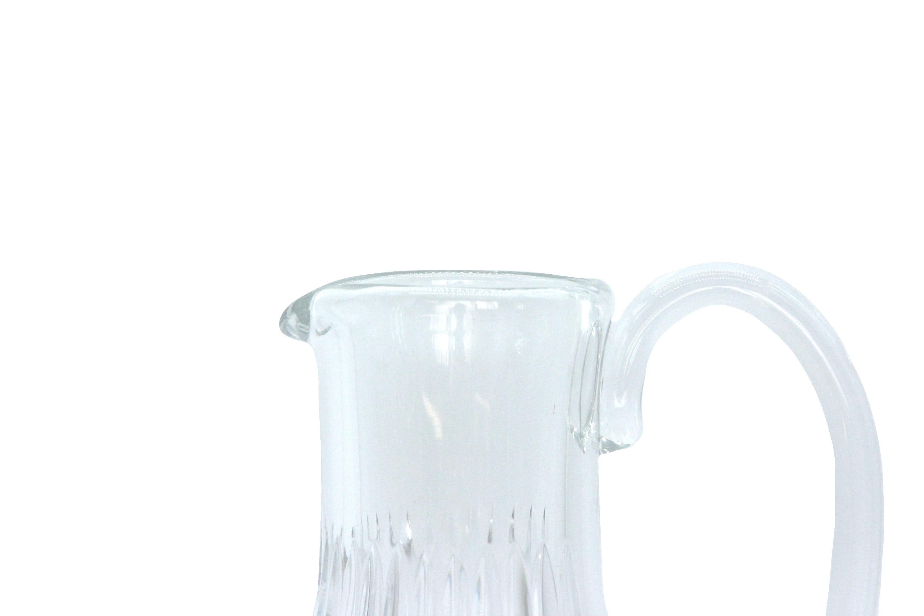 Baccarat crystal barware / tableware serving pitcher with side handle & exterior cut crystal design details. The pitcher is in great condition. Maker's mark etched undesigned. Minor wear. The pitcher stands about 9 1/2 inches x 6 inches.