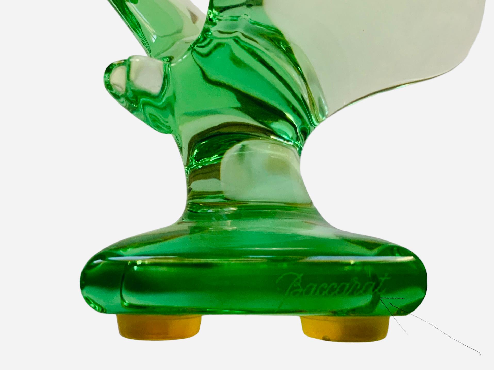 This is a Baccarat Crystal Butterfly sculpture/figurine . It depicts a light green translucent crystal butterfly with its large wings open up supported also by a square crystal base. It has the acid etched hallmark of Baccarat, France in one of the
