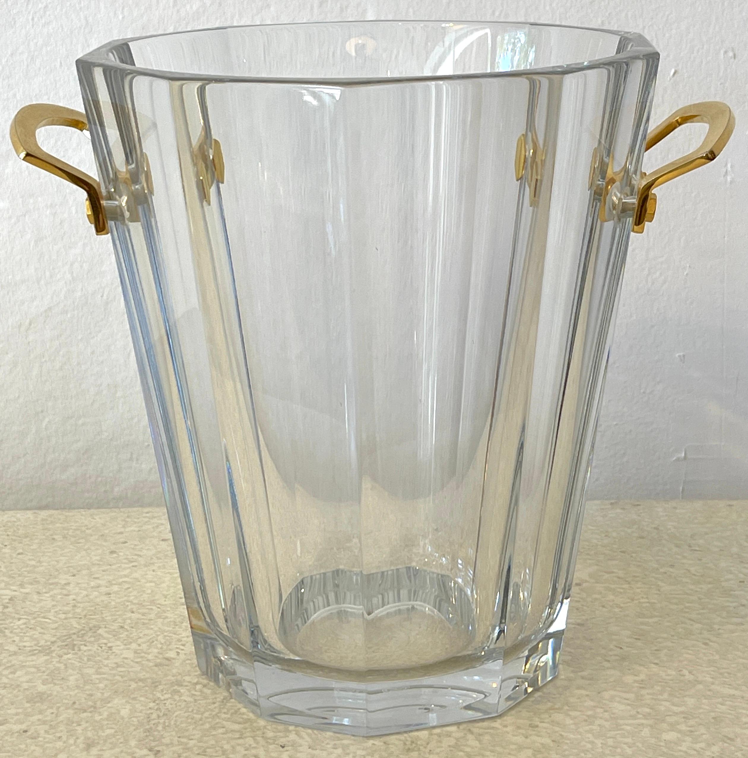 Baccarat crystal & gilt bronze champagne bucket, with continuous cut panel sides fitted with twin gilt bronze handles, one signed 'Baccarat', the crystal is also signed 'Baccarat'. The interior measures 9