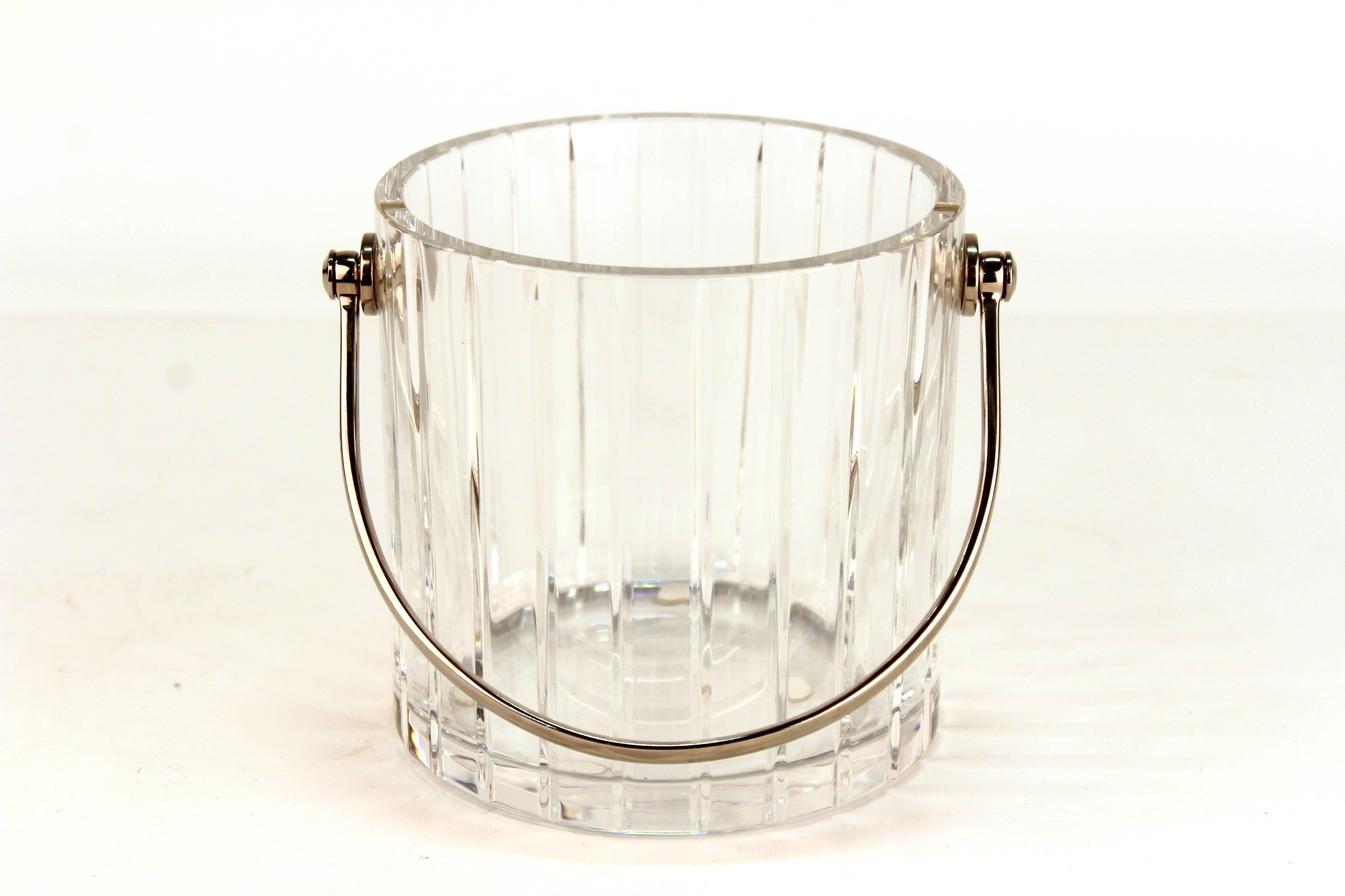 A Baccarat crystal ice bucket from the 'Harmonie' collection, with vertical cut stripes and stainless steel handle. The underside has the etched makers mark. The piece is in great vintage condition.