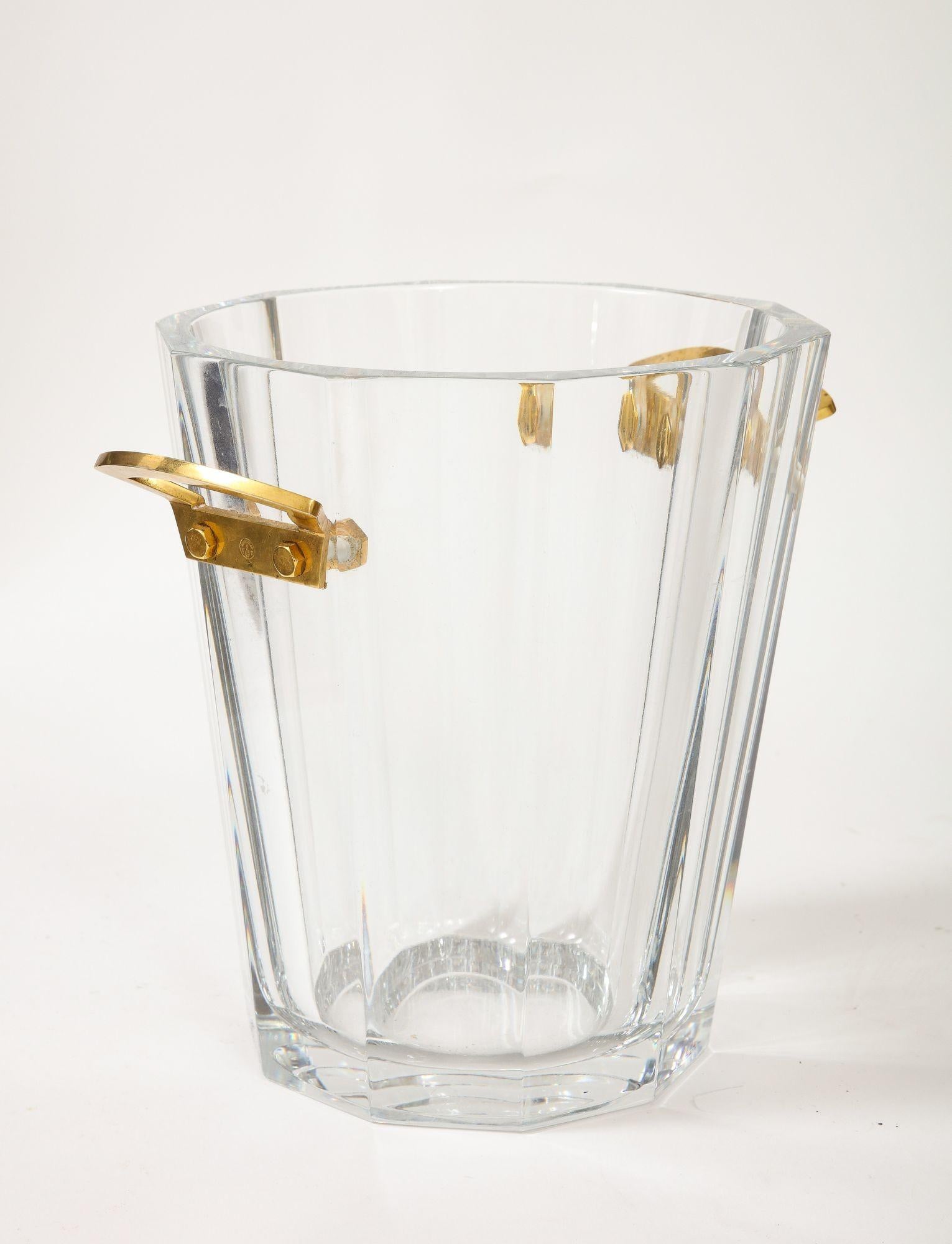 A beautiful baccarat Crystal Ice Bucket with faceted edges and gilded bronze handles with an etched makers mark.