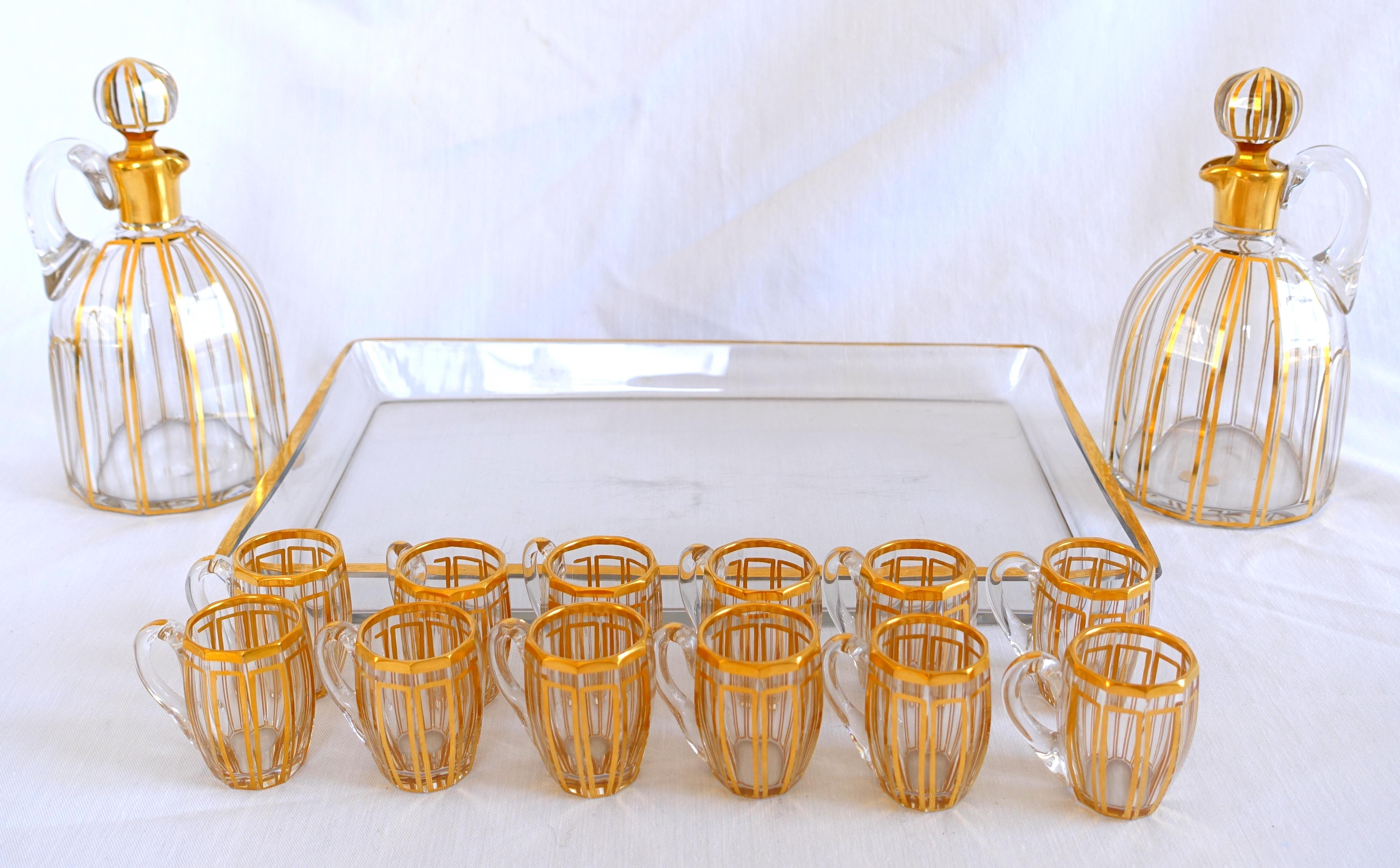 Gilt Baccarat crystal liquor set for 12, Cannelures cut pattern enhanced with gold