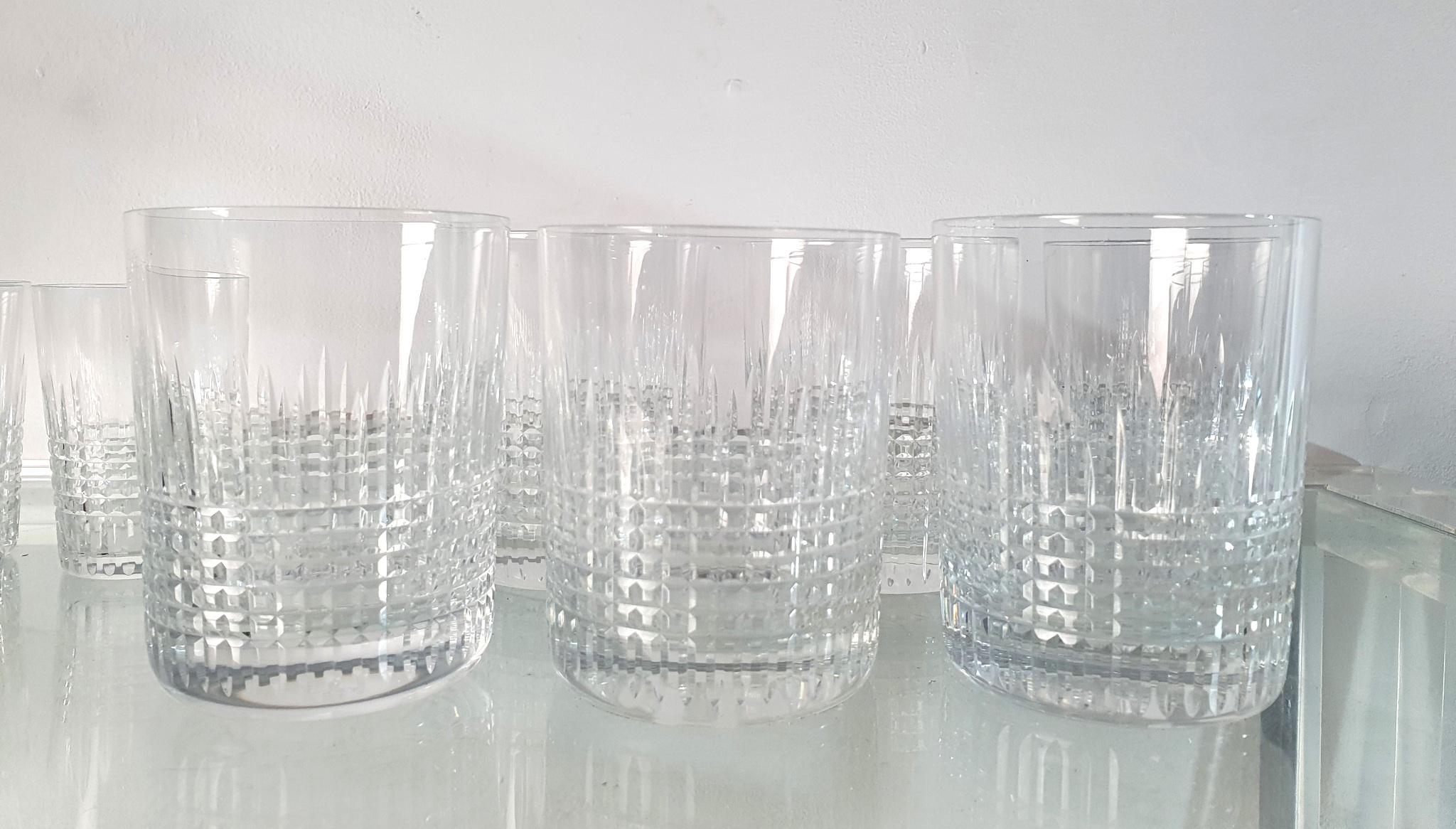 A wonderful vintage set of 6+6 Nancy tumbler and water glasses by Baccarat, France. Marked Baccarat, France in the bottom. No chipping or damage.

The Nancy Tumbler is characterized by its delicate crosshatching of lines etched into the base of