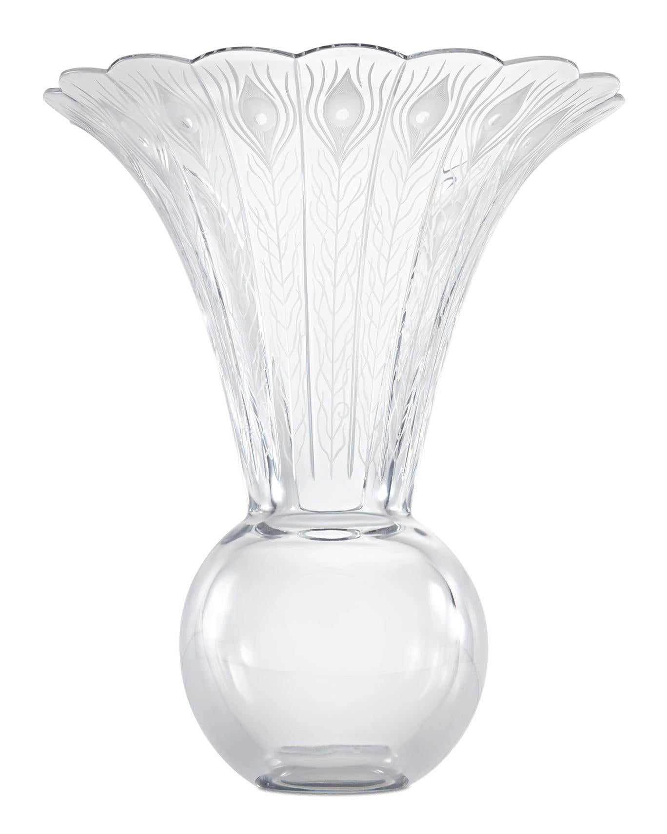 This rare and beautiful vase boasts the superb workmanship of famed French crystal firm Baccarat. The design takes the abstract form of a peacock, featuring a long neck which flares to a flute, etched with the pattern of peacock feathers. A round,
