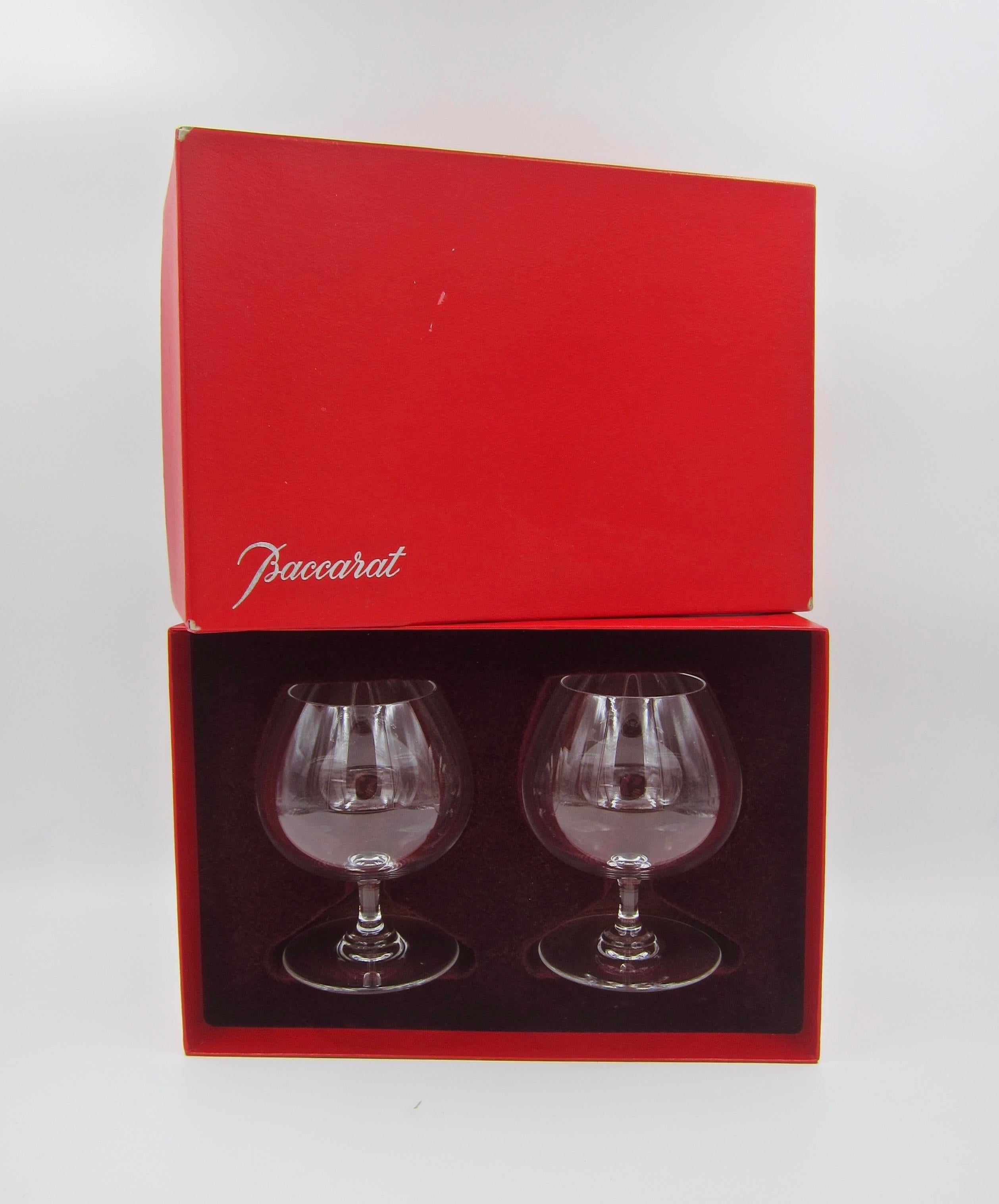 A boxed pair of handmade mouth-blown colorless crystal brandy snifters from France. From Baccarat's perfection line, each clear crystal glass is designed with a short stem and a wide balloon-like crystal bowl enabling scents and notes to be released