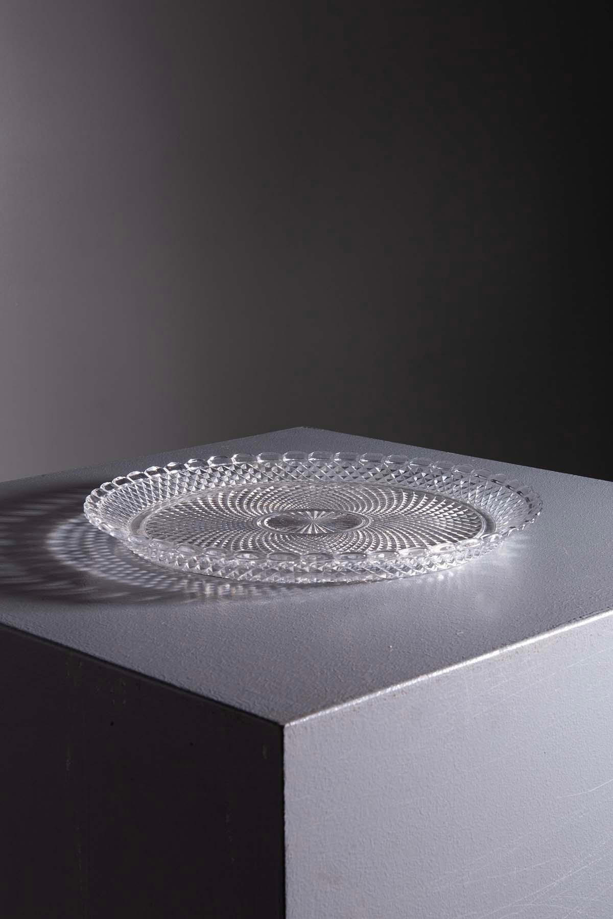 Welcome to the Fascinating World of Crystal Artistry with this Extraordinary Baccarat Crystal Serving Plate from the '70s.
Originally hailing from a sumptuous Milanese residence, this one-of-a-kind piece captures the essence of timeless