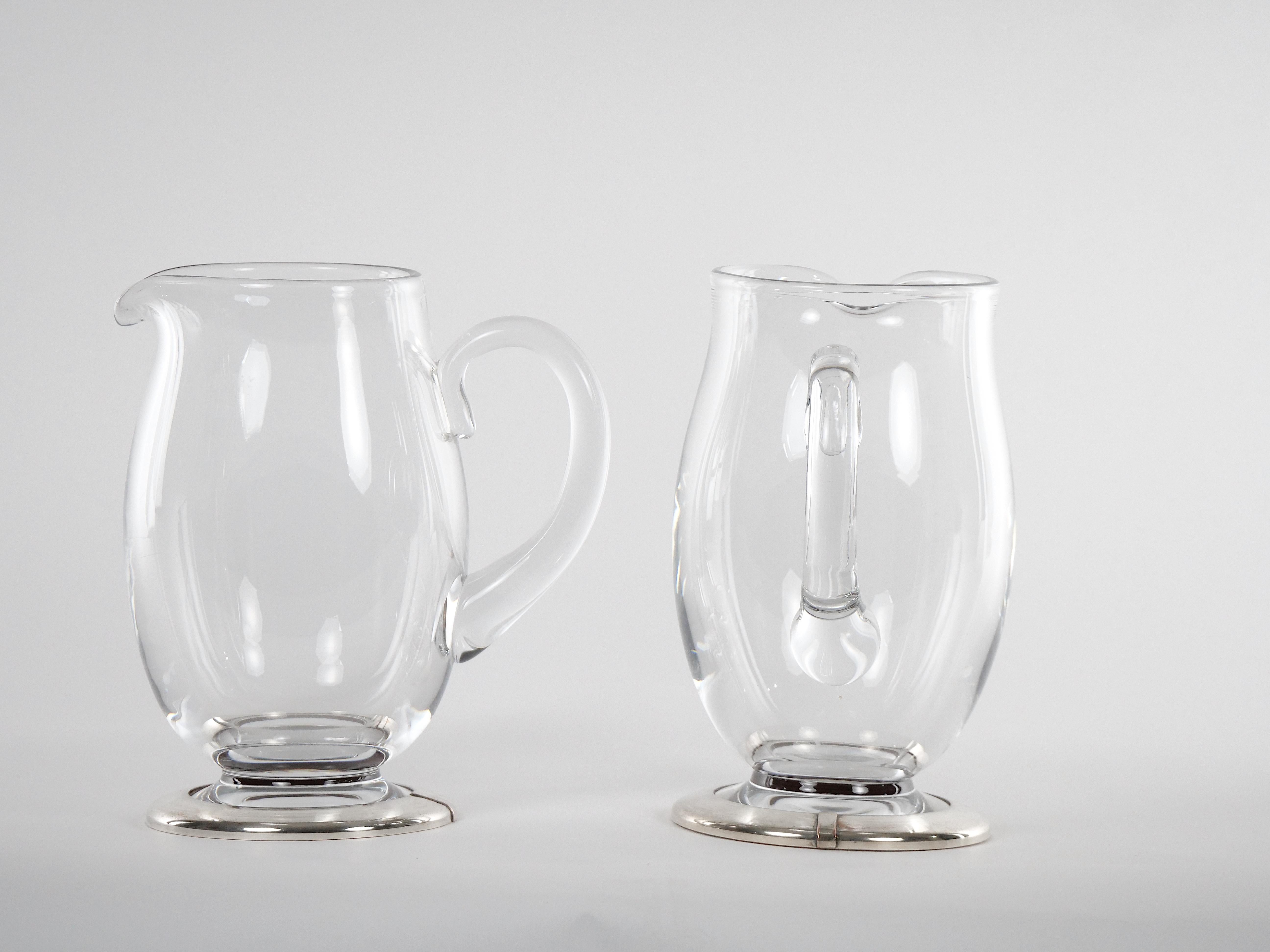 Hand Crafted pair baccarat crystal with silver plate base tableware / barware serving pitcher. Each pitcher features a very clean line & pleasing look in the art deco style with a round silver plate base. Each pitcher is without any cracks, chips or
