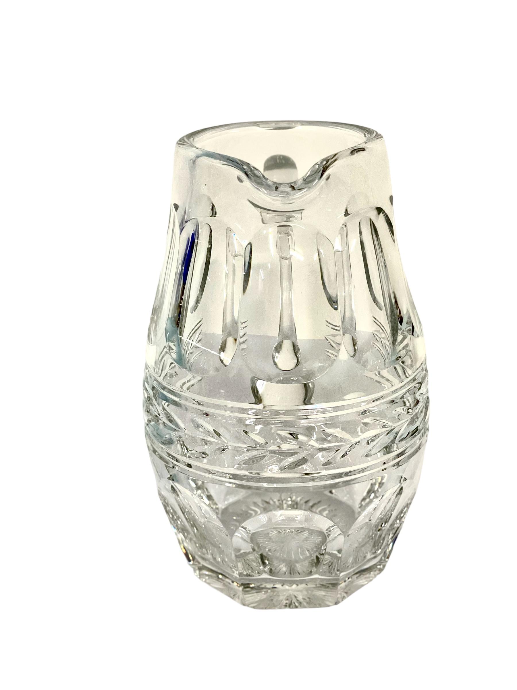 A superb heavy crystal water pitcher from the renowned house of Baccarat. This highly decorative handcrafted water jug, with its elegant and ergonomic handle, is perfectly proportioned and highly functional, with a spout that pours beautifully. The
